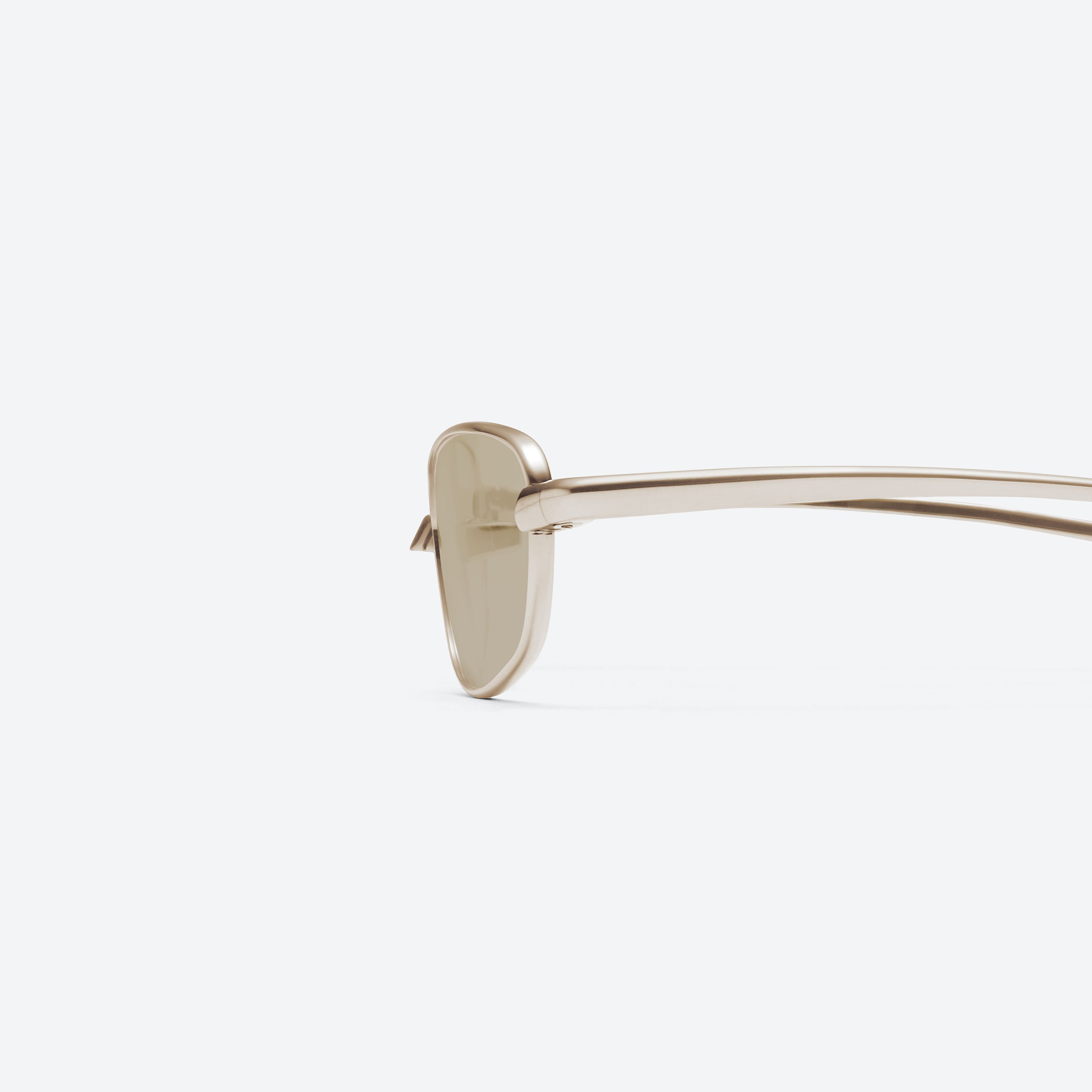 A detailed left view of Gentle Monster Riff 037 Gold Metal framed Square glasses.