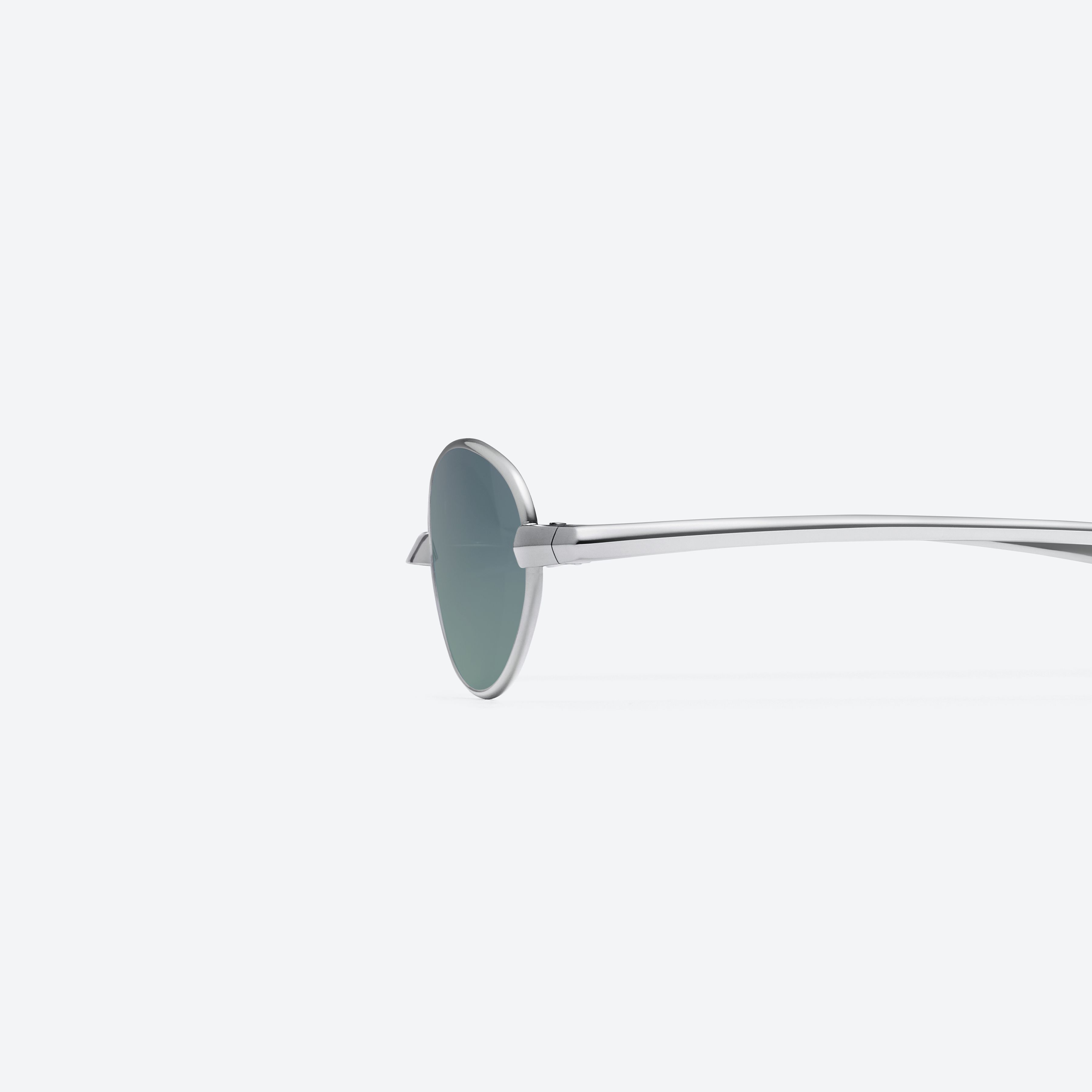 A detailed left view of Gentle Monster Faust 02(MGR) Silver Metal framed Oval glasses.