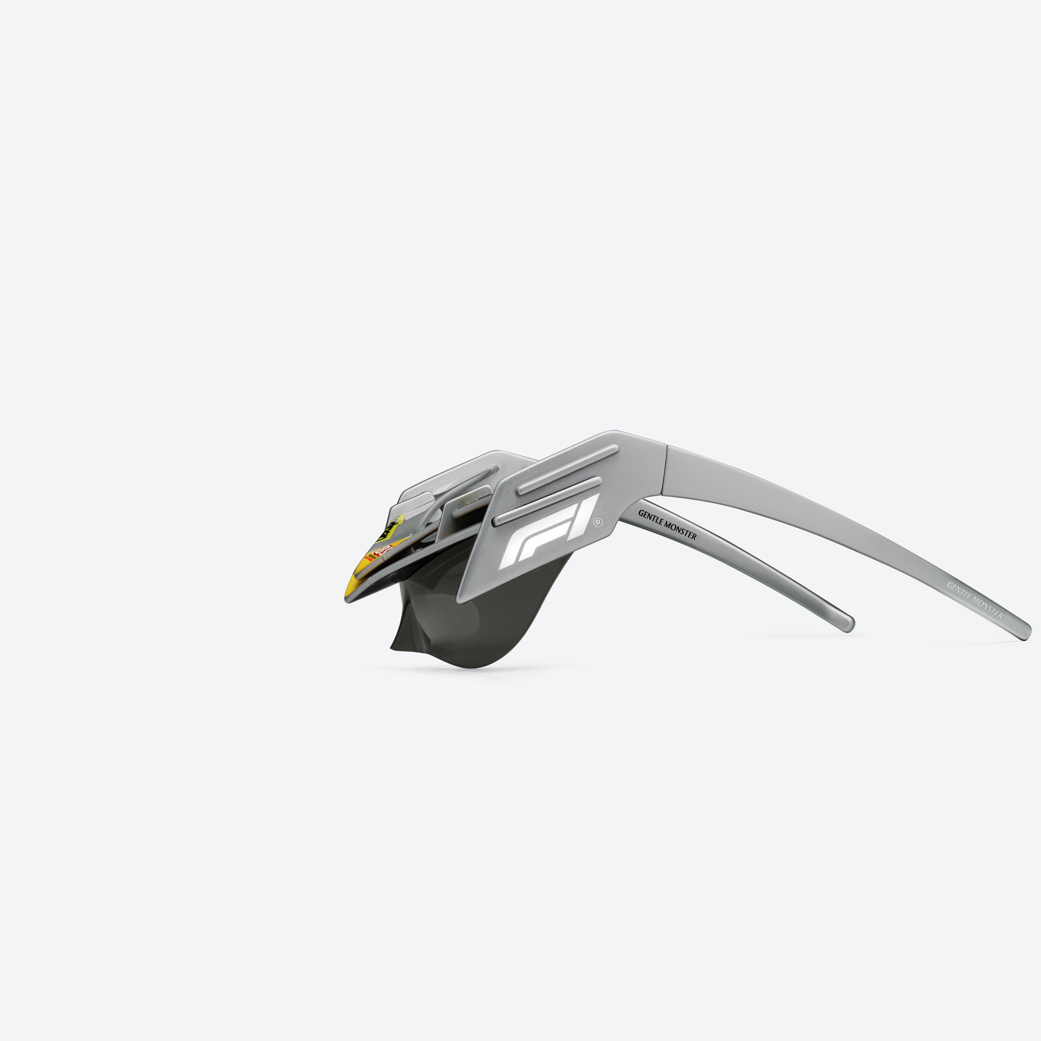 A detailed left view of Gentle Monster Disney F1 - Wing 4 G21 Gray Nylon framed Wraparound sunglasses.