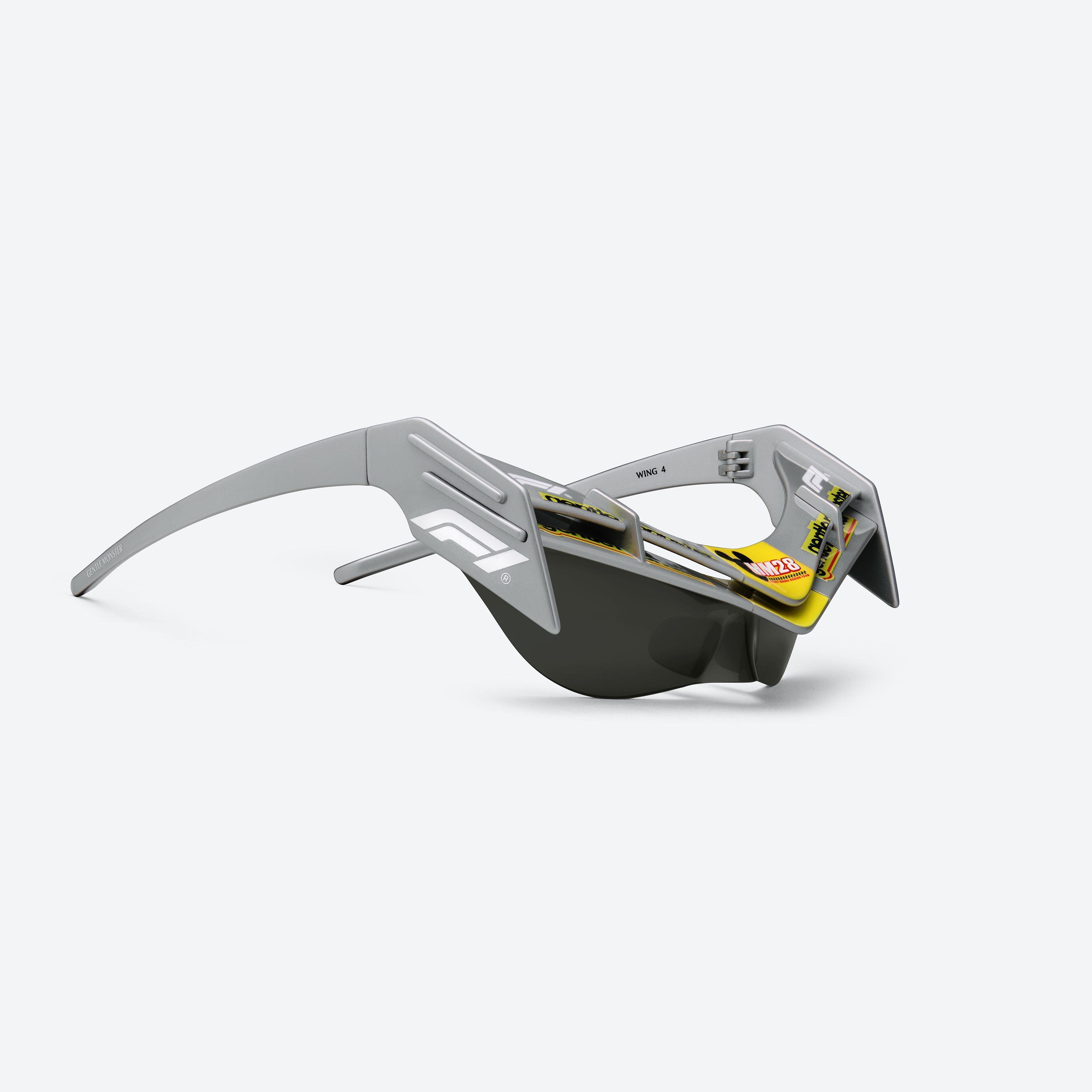45-degree detailed view of Gentle Monster Disney F1 - Wing 4 G21 Gray Nylon framed Wraparound sunglasses.