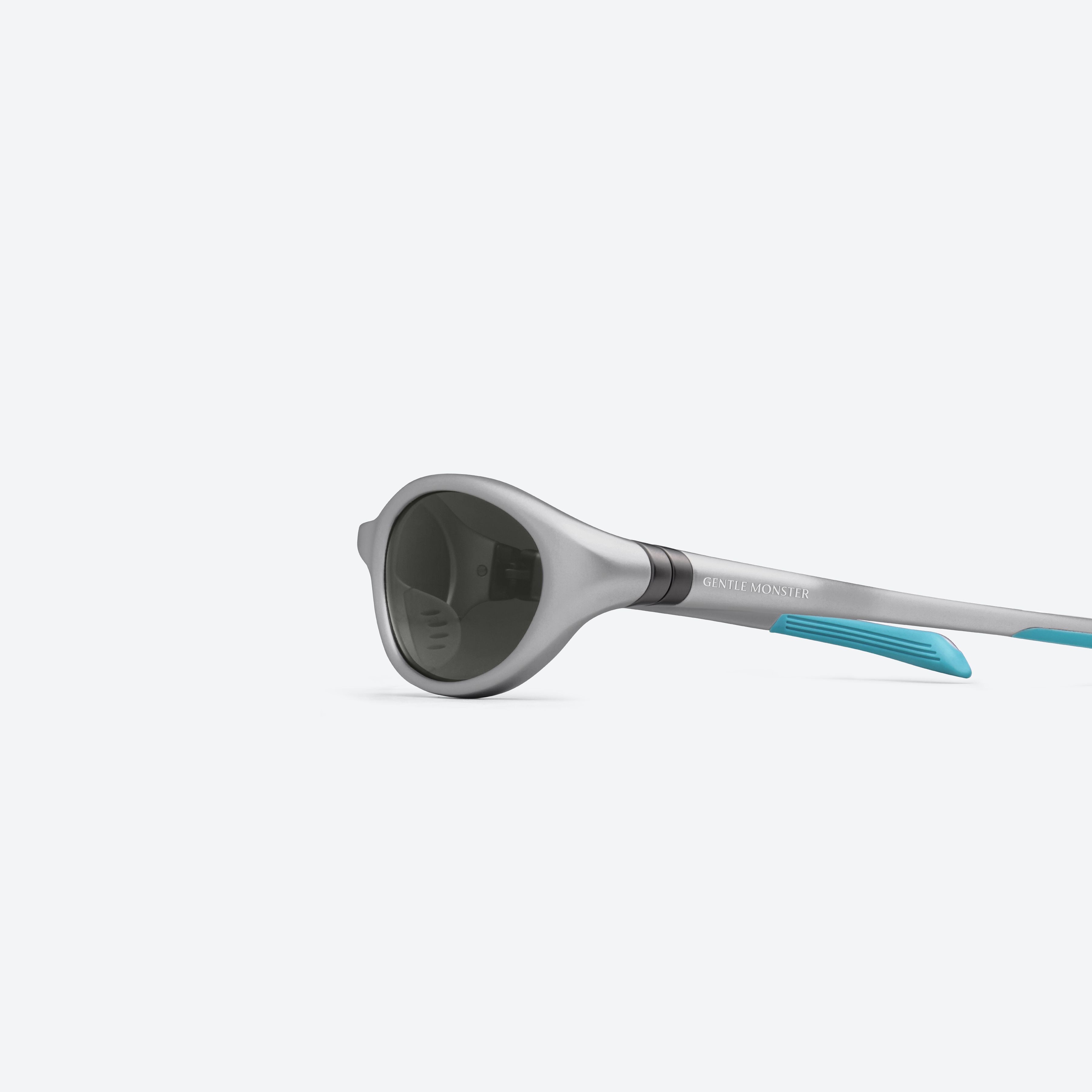A detailed left view of Gentle Monster VELO MG21 Gray Nylon framed Wraparound sunglasses.