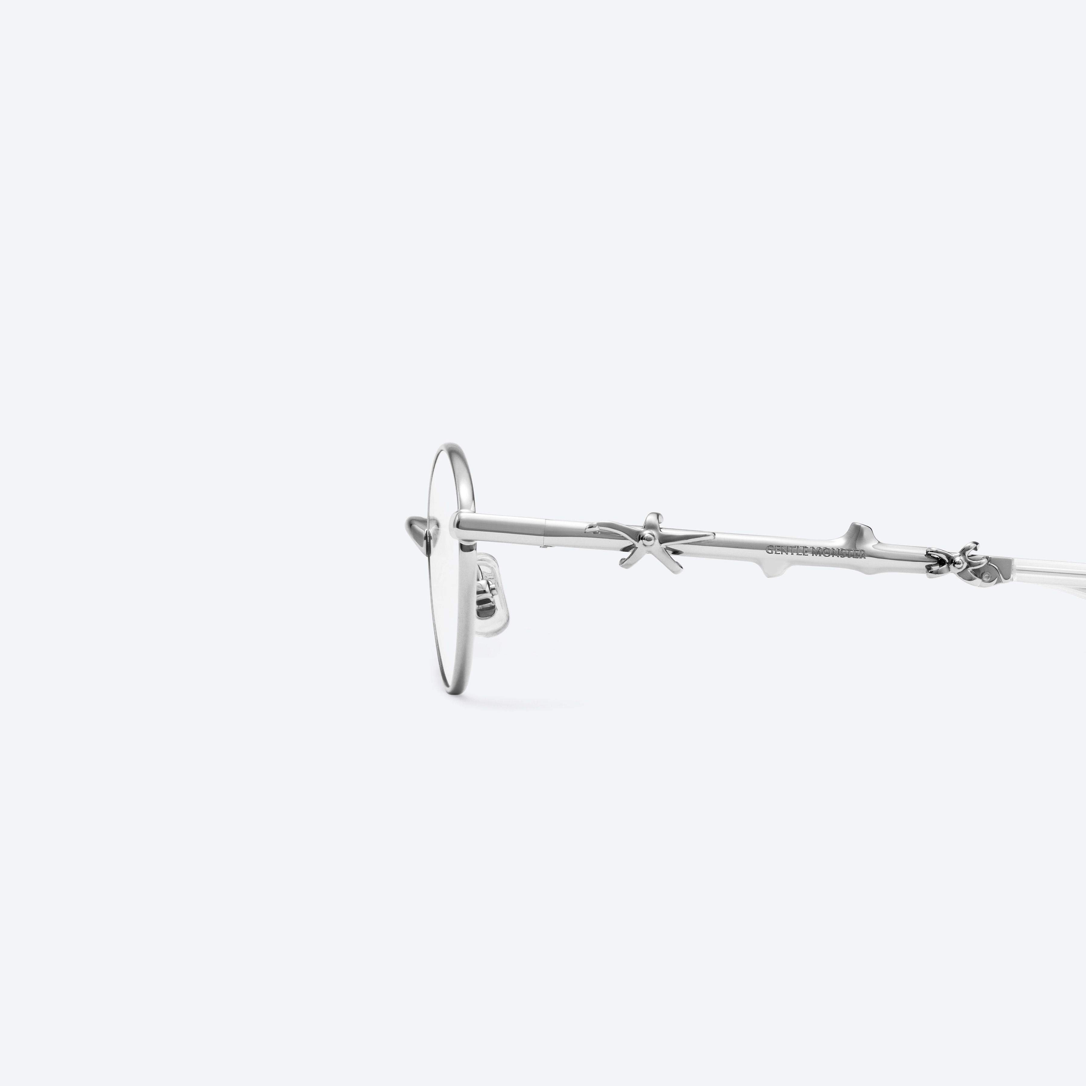 A detailed left view of Gentle Monster Aden 02 Silver Metal framed Oval glasses.