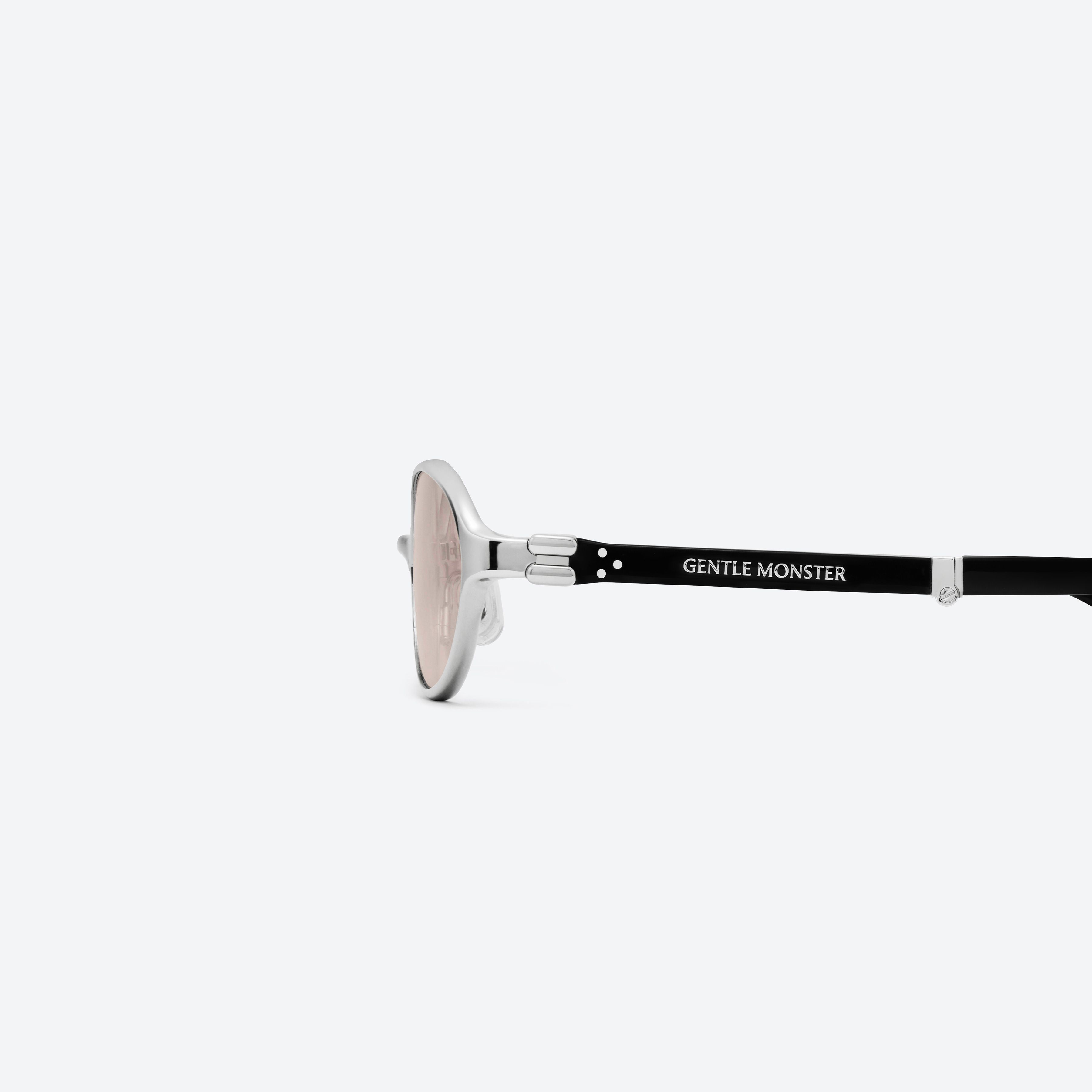 A detailed left view of Gentle Monster Oatt 02 Silver Mixed framed Oval sunglasses.