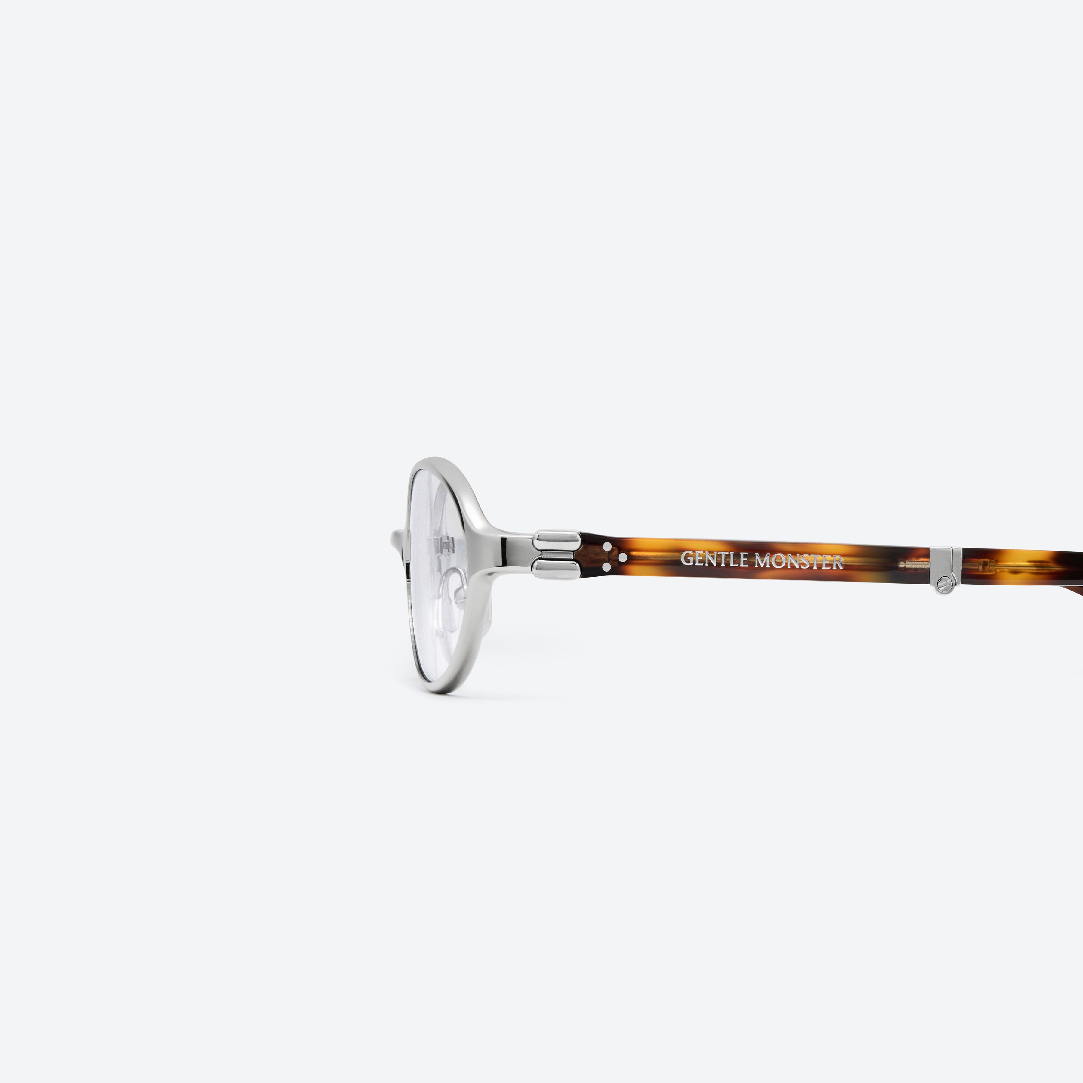 A detailed left view of Gentle Monster Oatt 02(C) Silver Mixed framed Oval glasses.