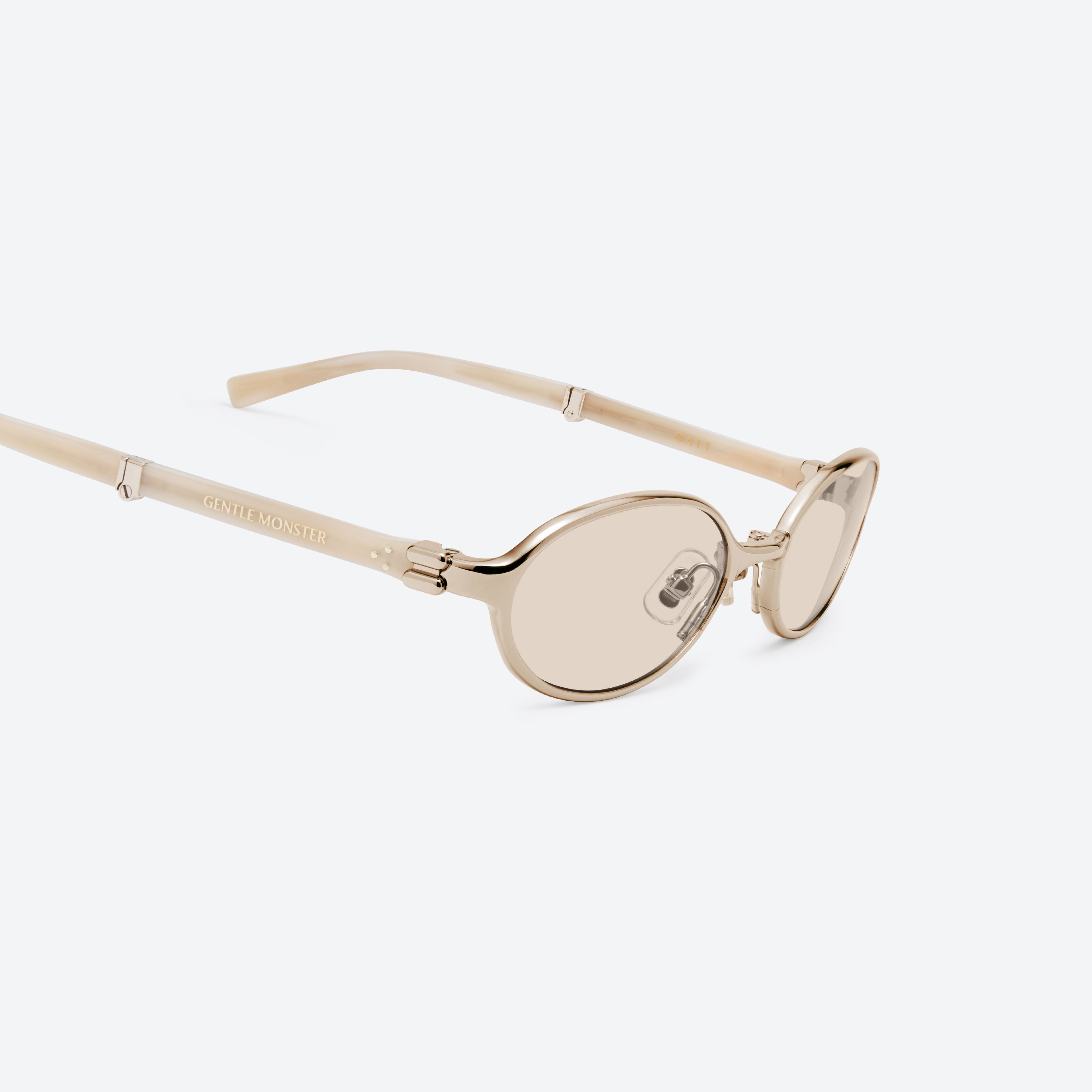 45-degree detailed view of Gentle Monster Oatt 031 Gold Mixed framed Oval sunglasses.