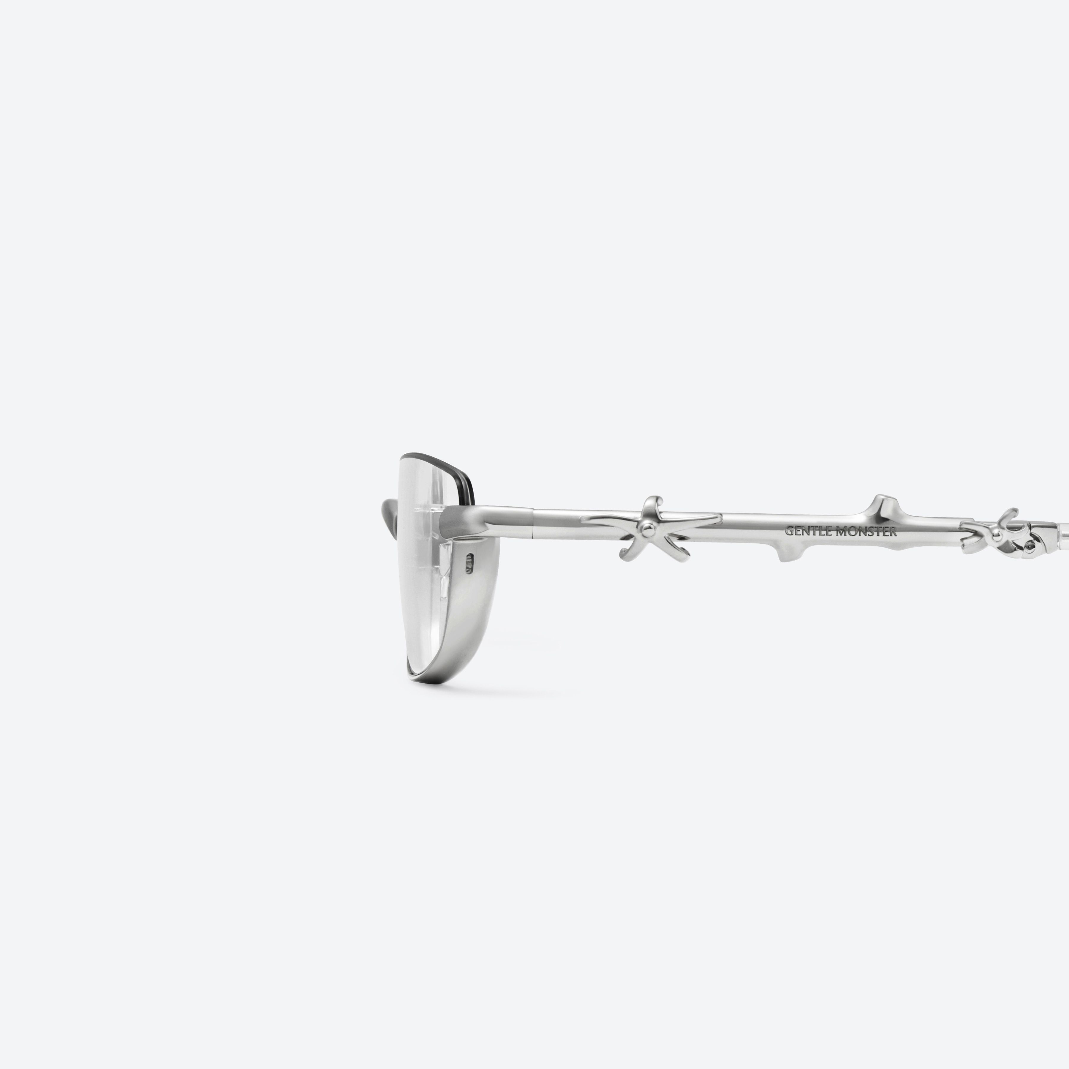 A detailed left view of Gentle Monster Vert 02 Silver Metal framed Square glasses.