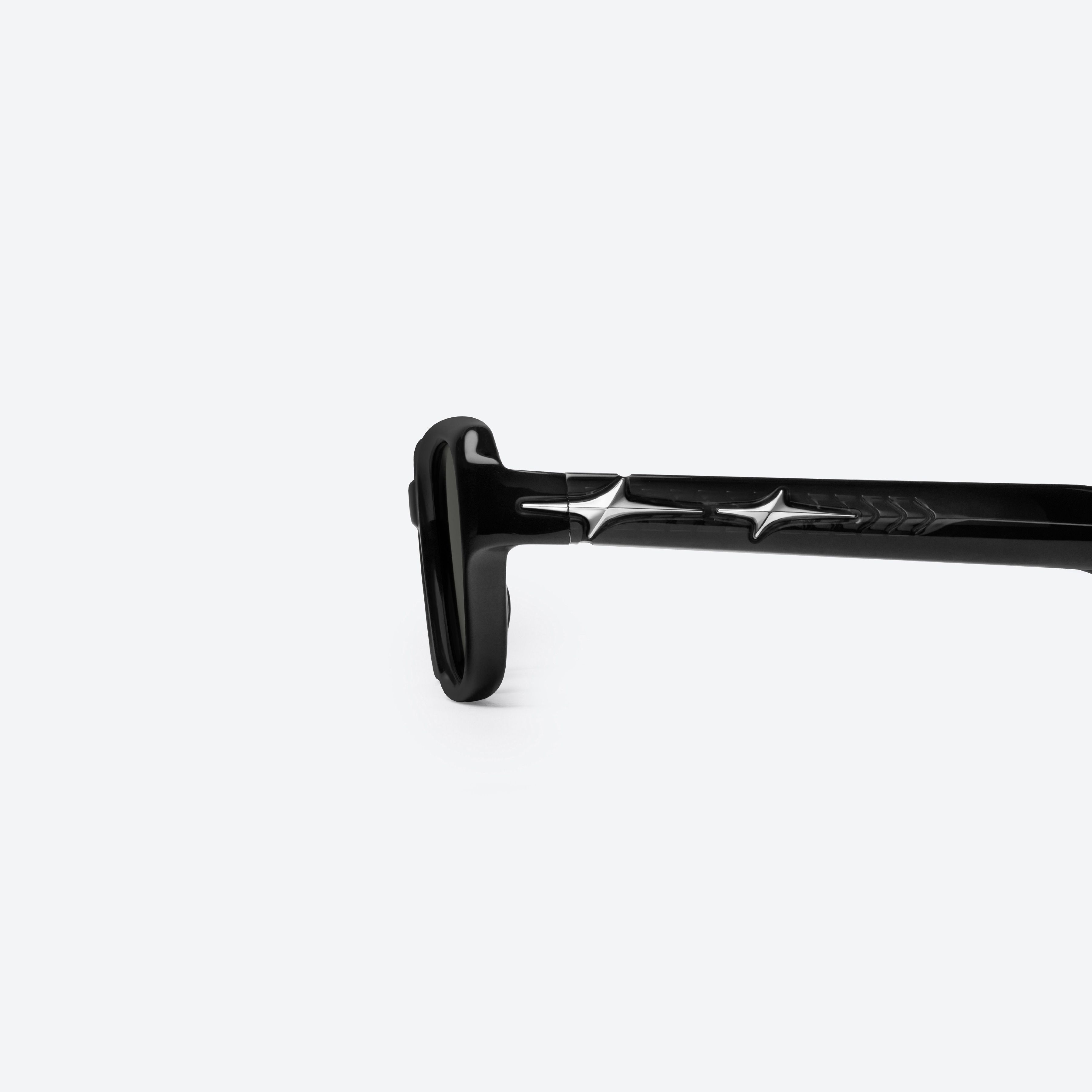 A detailed left view of Gentle Monster Comte 01(G) Black Acetate framed Square glasses.