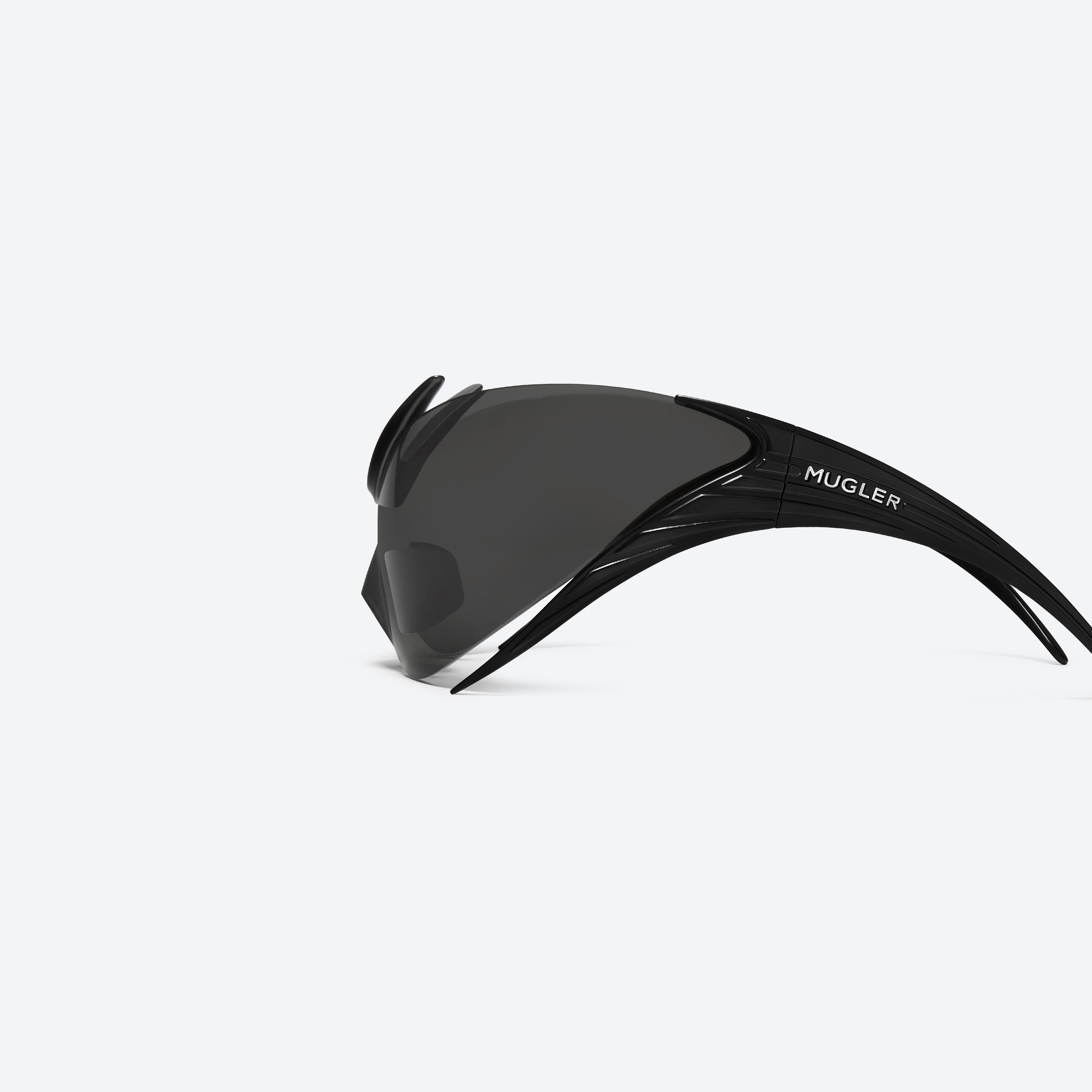 A detailed left view of Gentle Monster Mugler - Spiral 01 M01 Black Nylon framed Wraparound sunglasses.