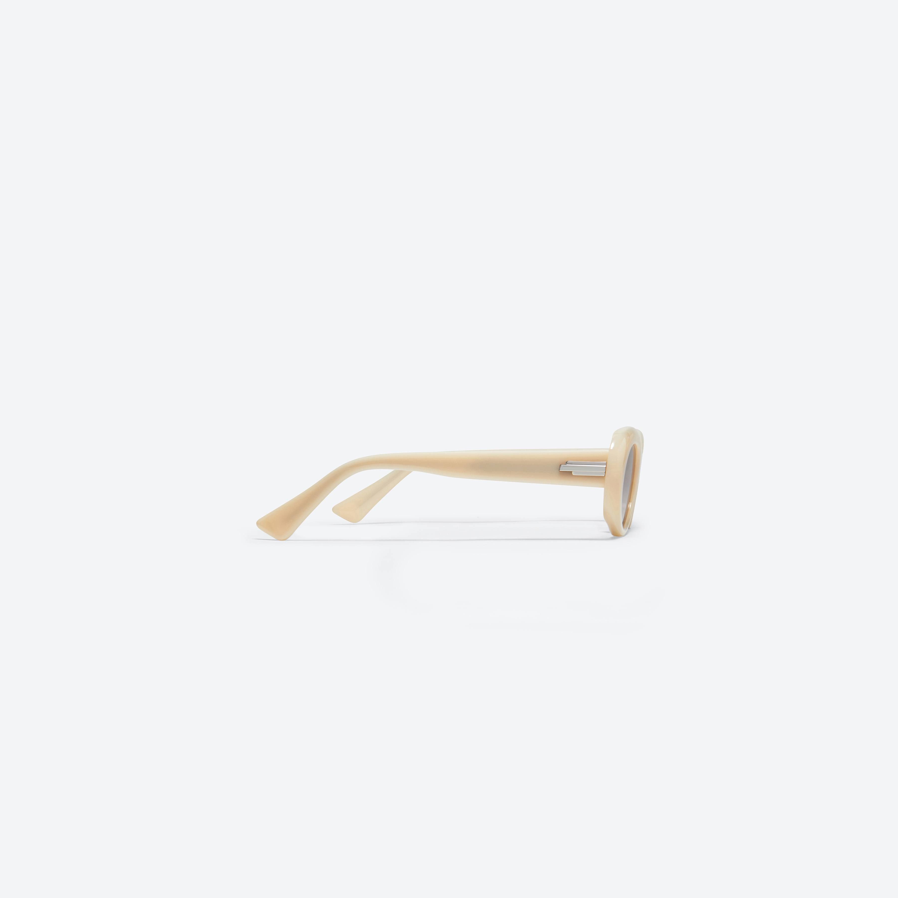 A detailed right view of Gentle Monster Le IV1 Ivory Acetate framed Oval sunglasses.