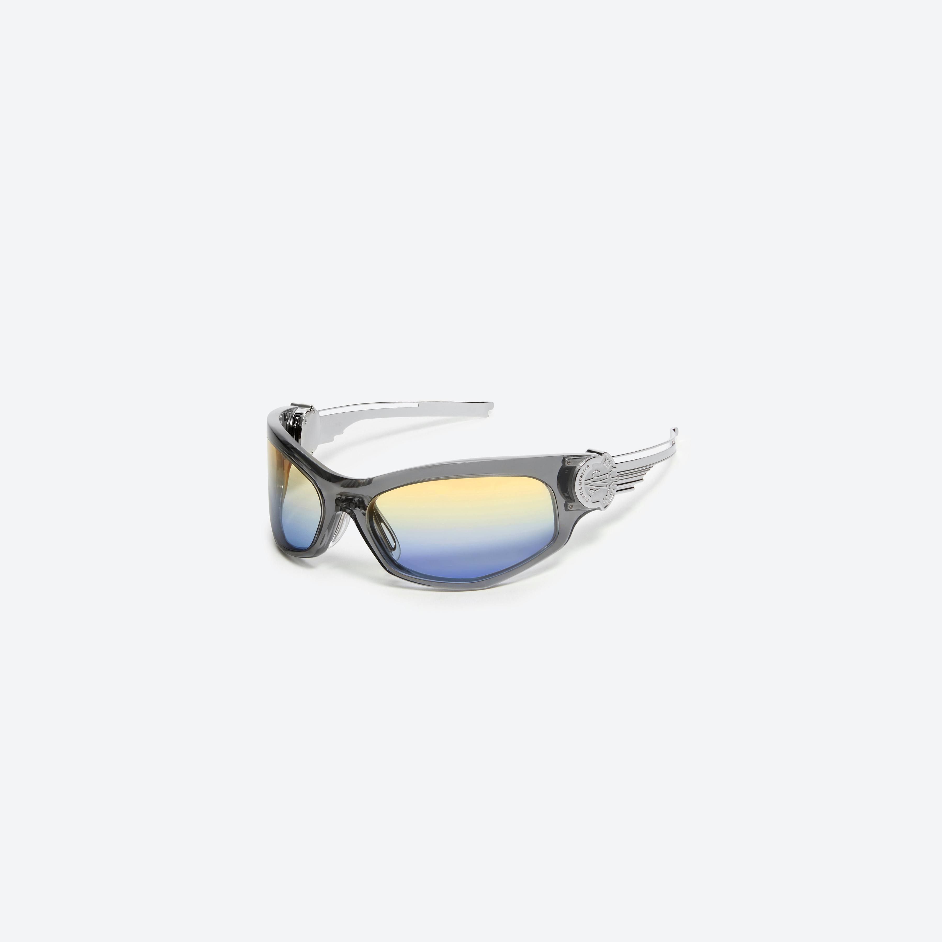 45-degree view of Gentle Monster Moncler - Swipe 1 G1 Gray Mixed framed Wraparound sunglasses.