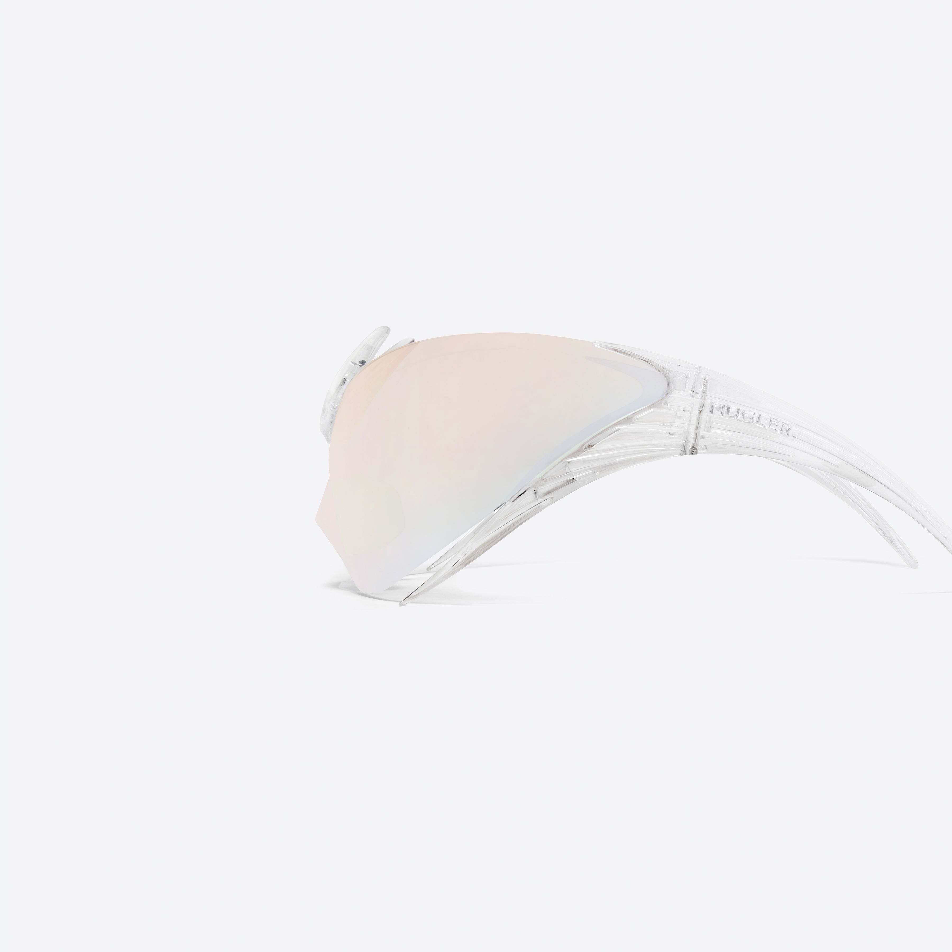 A detailed left view of Gentle Monster Mugler - Spiral 01 C1 Clear Nylon framed Wraparound sunglasses.