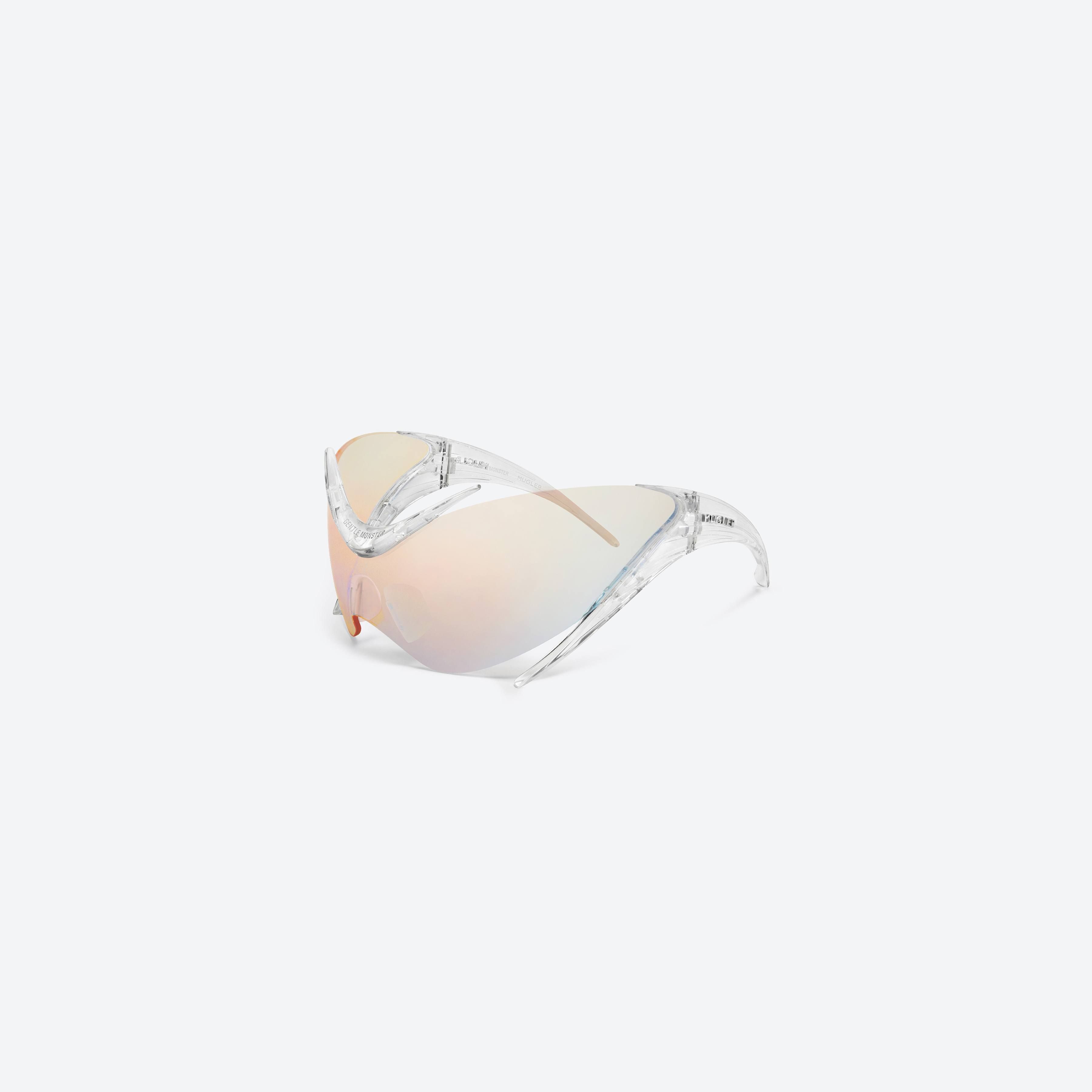 45-degree view of Gentle Monster Mugler - Spiral 01 C1 Clear Nylon framed Wraparound sunglasses.