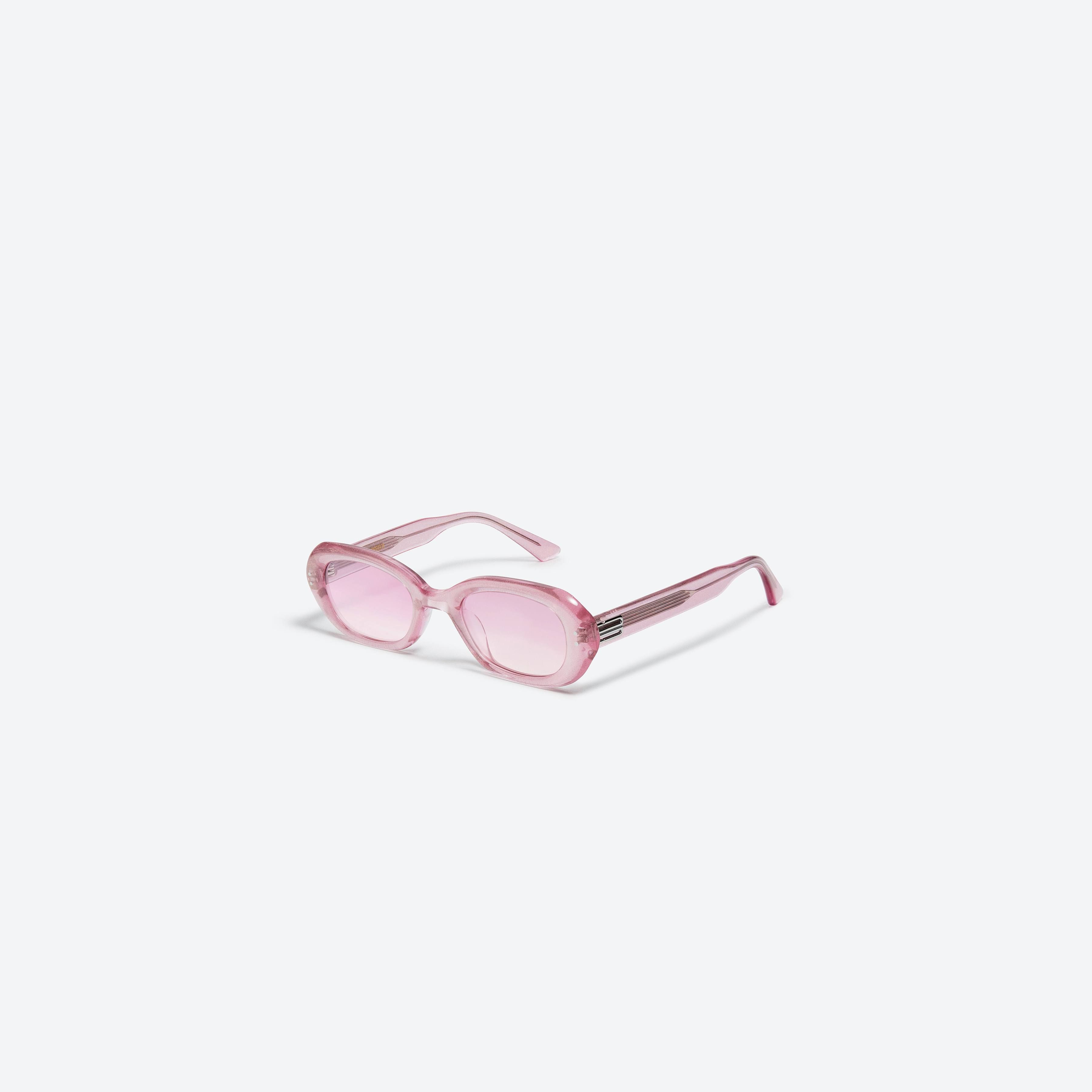 45-degree view of Gentle Monster Helix PC6 Pink Acetate framed Oval sunglasses.