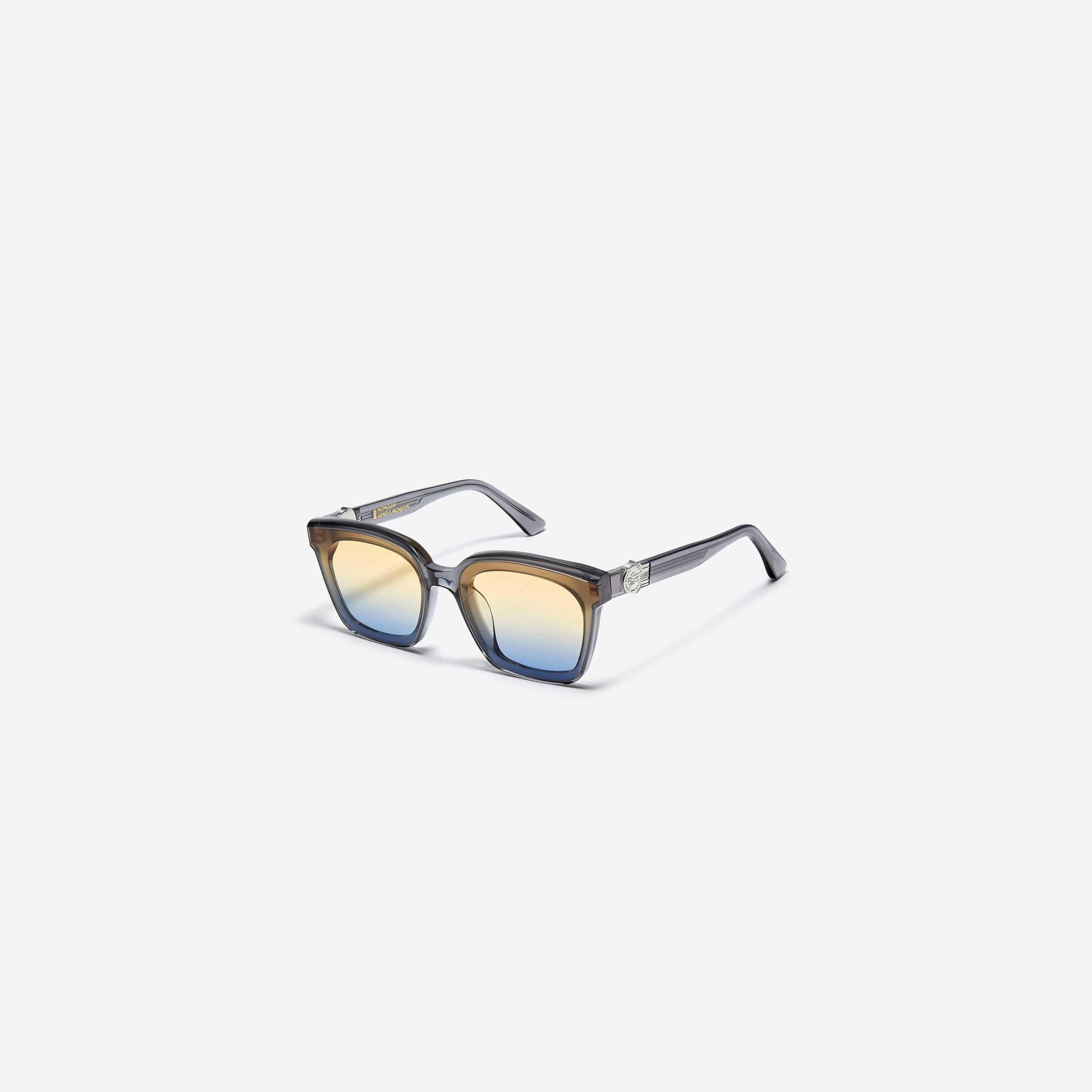 45-degree view of Gentle Monster Moncler - Swipe 3 G1 Gray Mixed framed Square sunglasses.