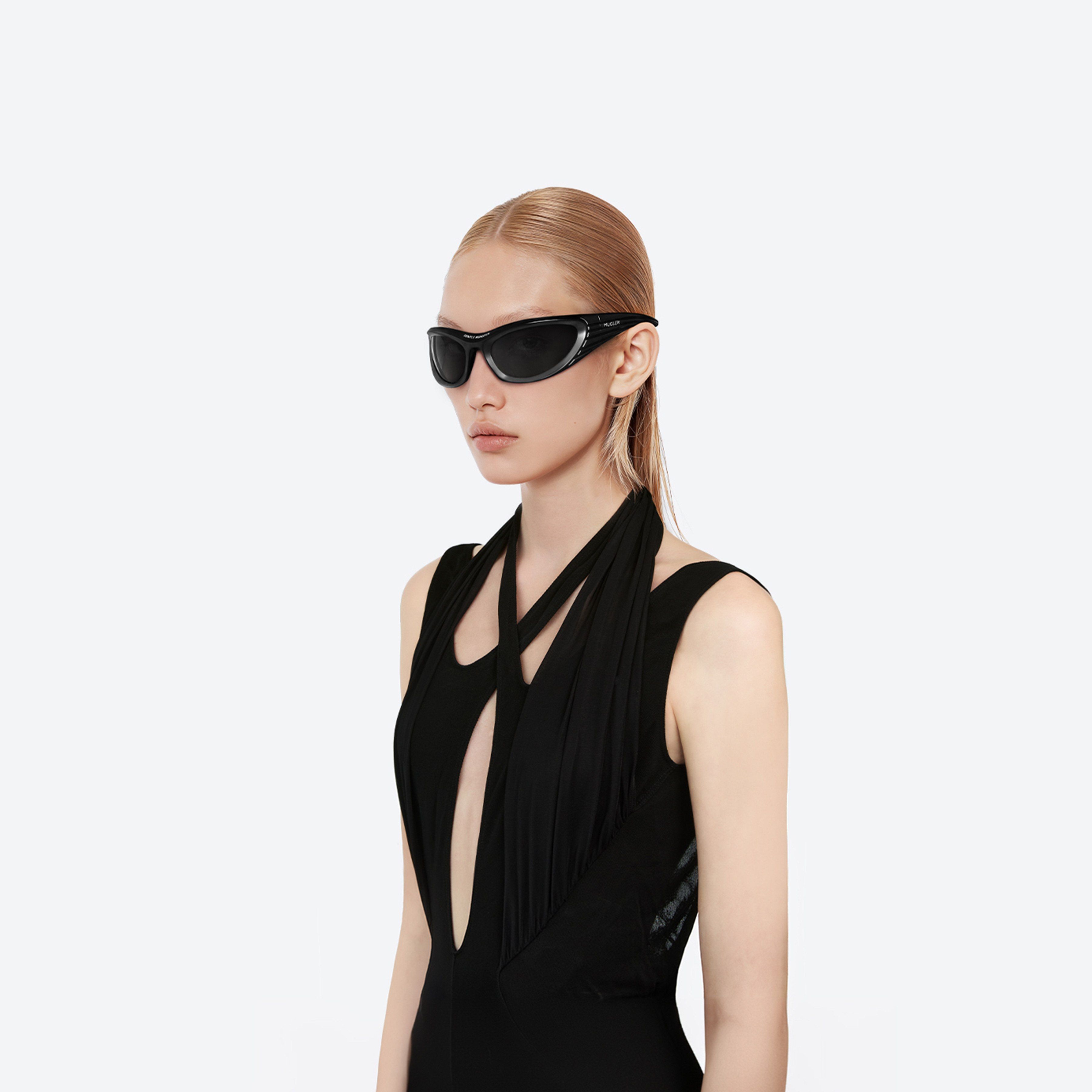 Model wearing the Mugler - Spiral 02 M01 Black Nylon framed Wraparound sunglasses.