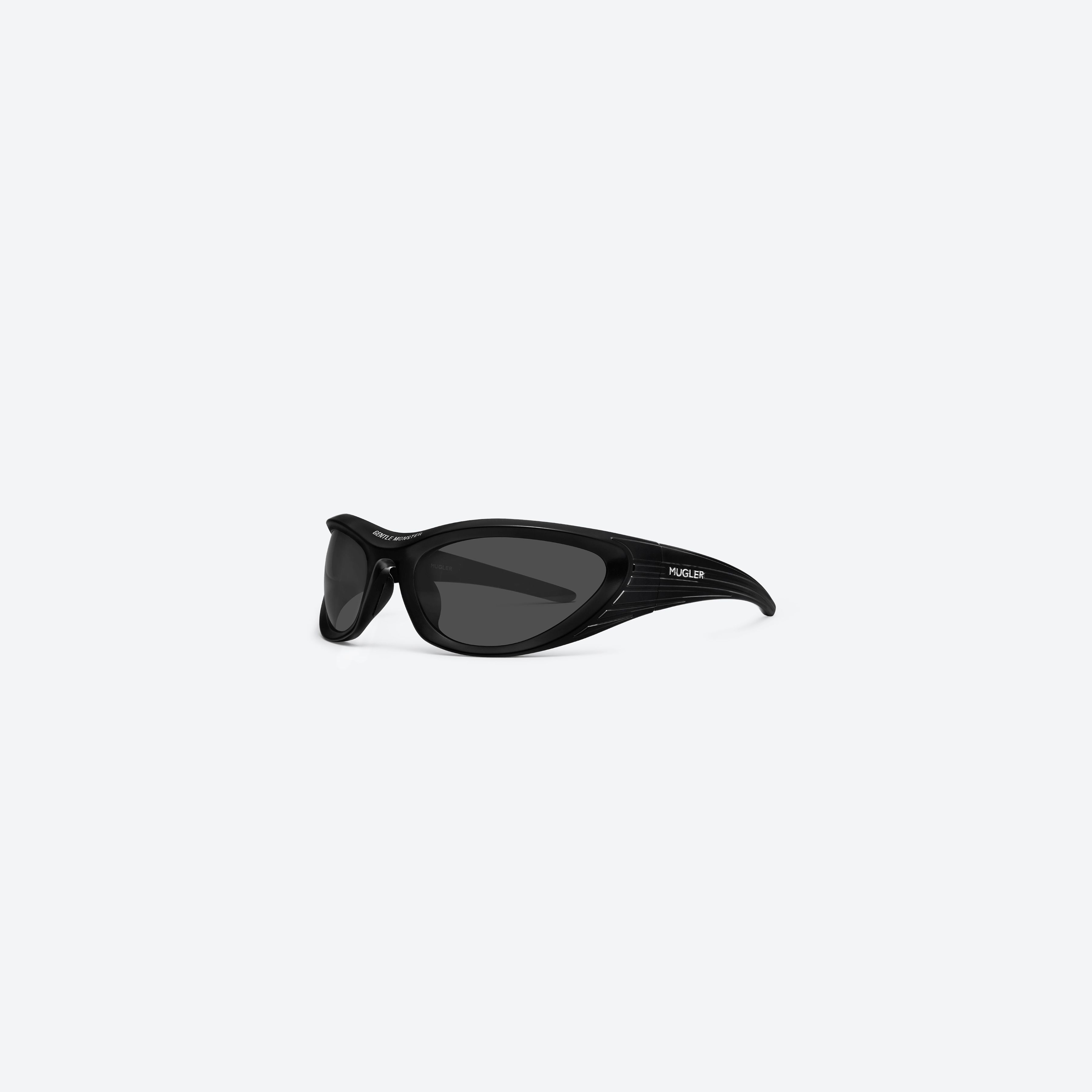 45-degree view of Gentle Monster Mugler - Spiral 02 M01 Black Nylon framed Wraparound sunglasses.