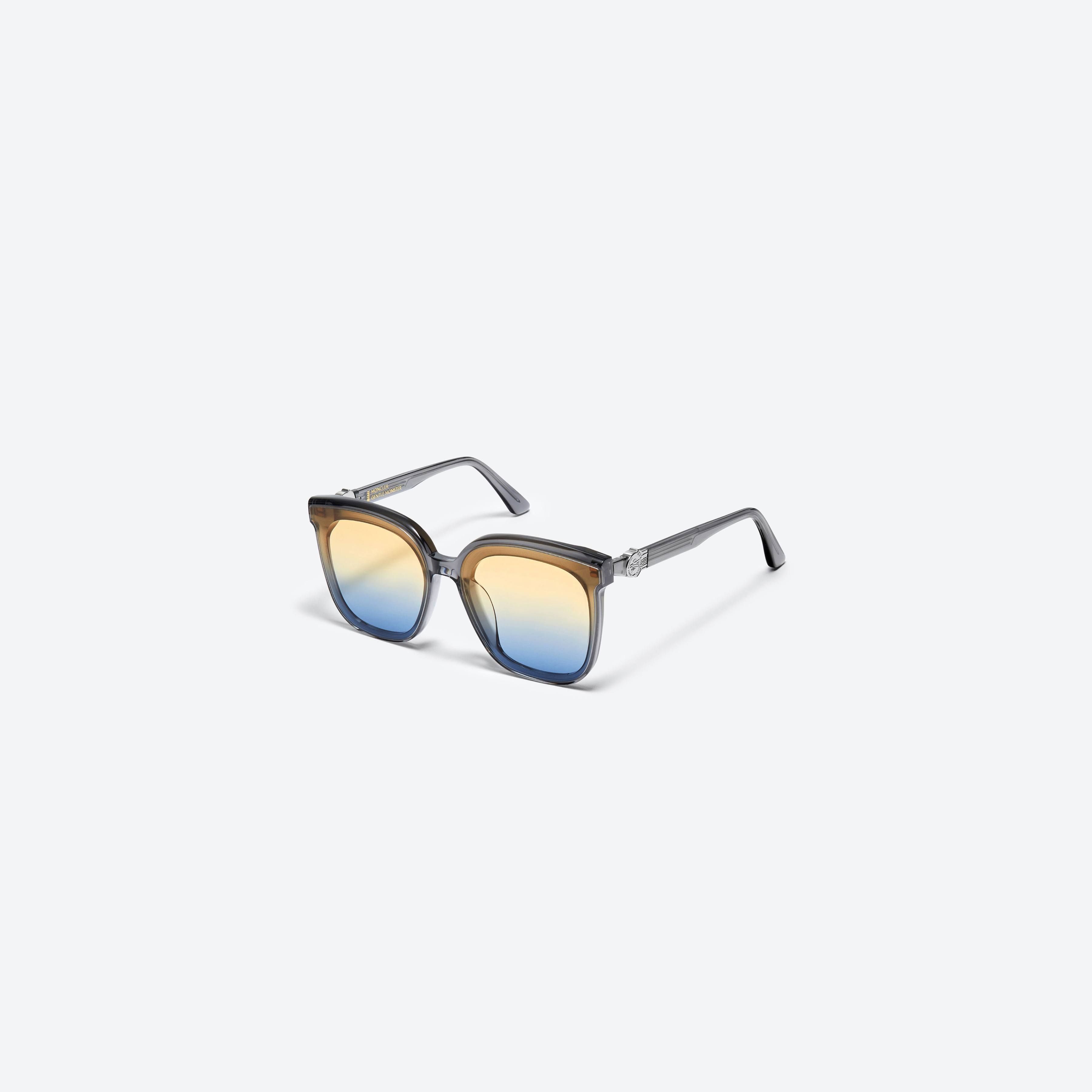 45-degree view of Gentle Monster Moncler - Swipe 4 G1 Gray Mixed framed Square sunglasses.
