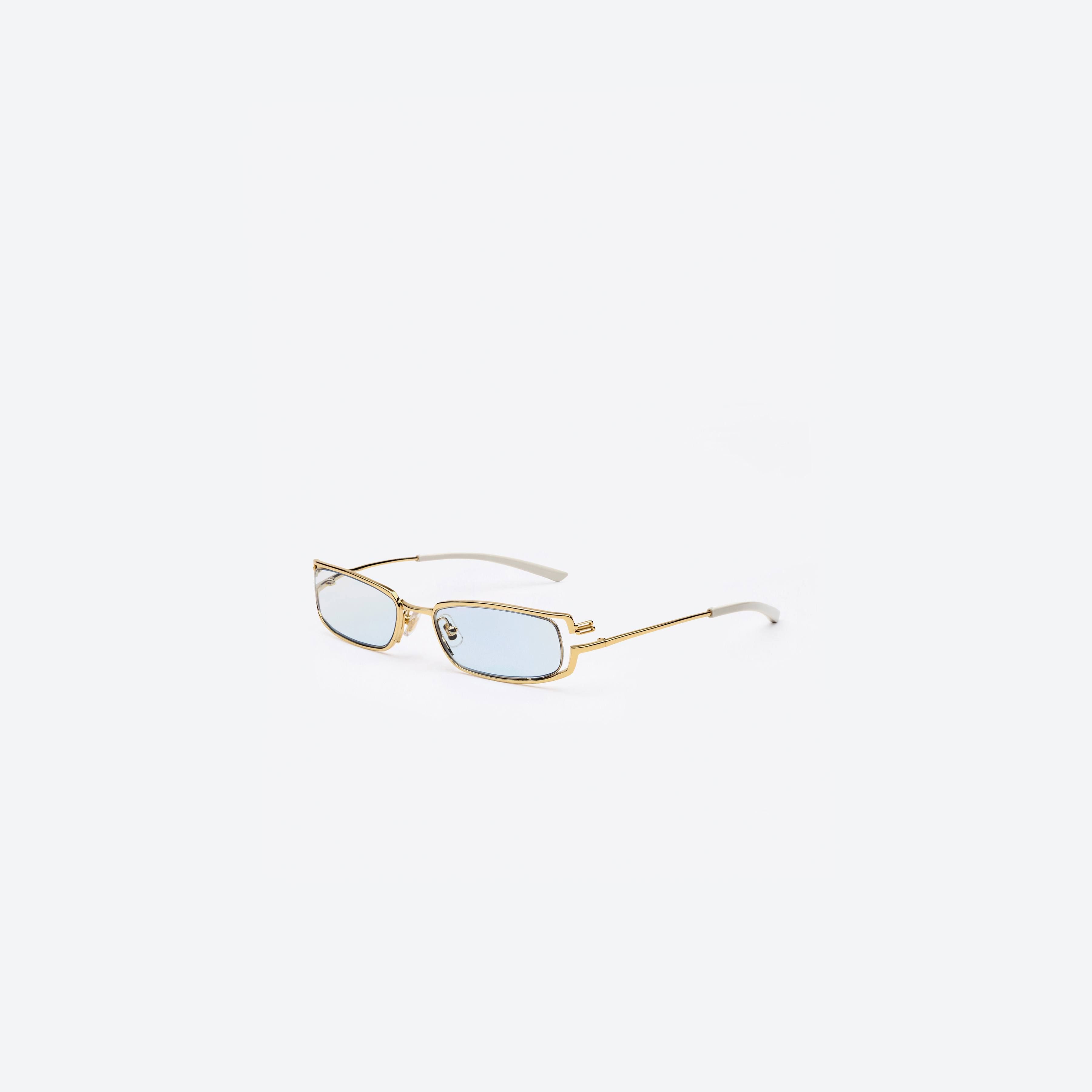 45-degree view of Gentle Monster Epic 03(BL) Gold Metal framed Square glasses.