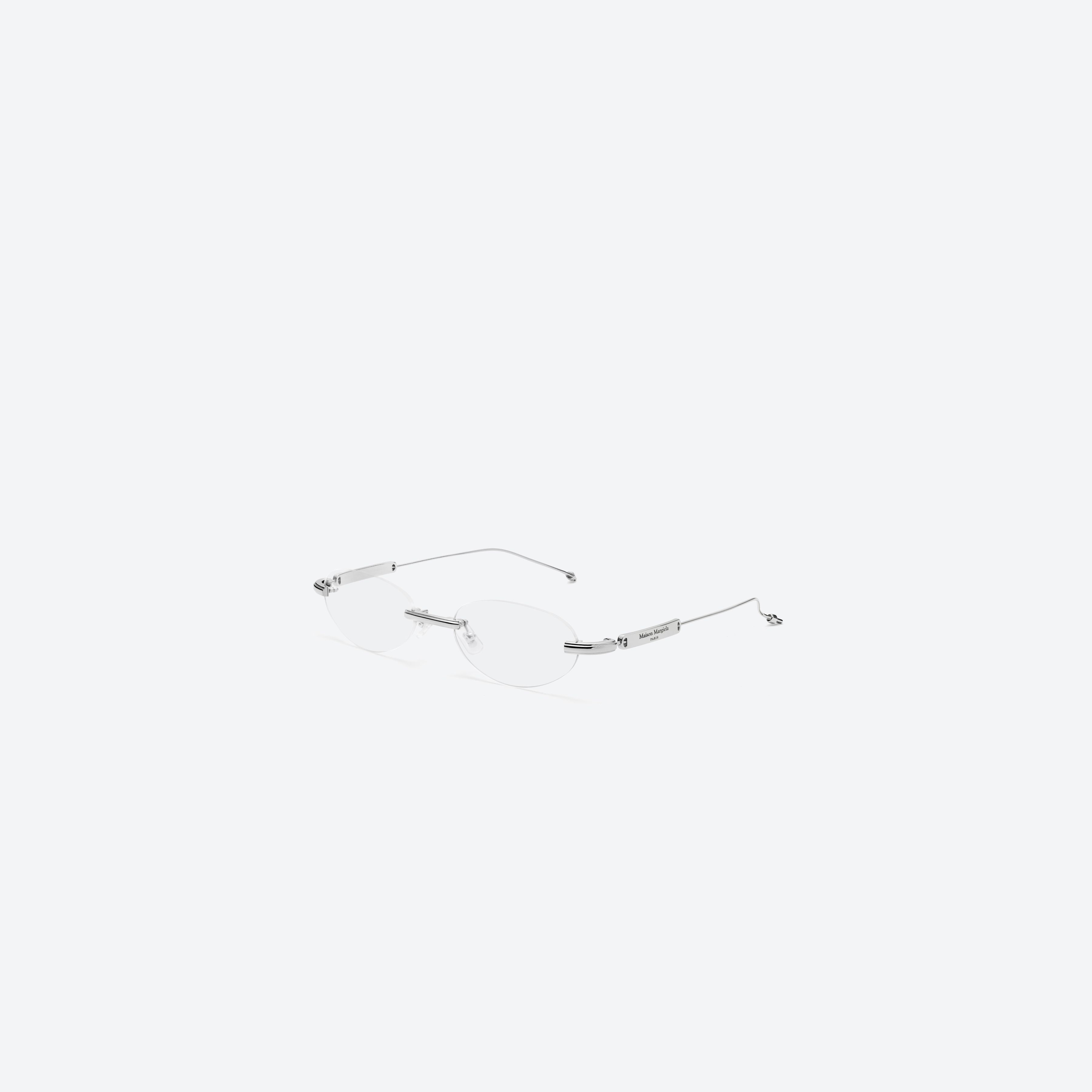 45-degree view of Gentle Monster MM217 02 Silver Metal framed Oval glasses.