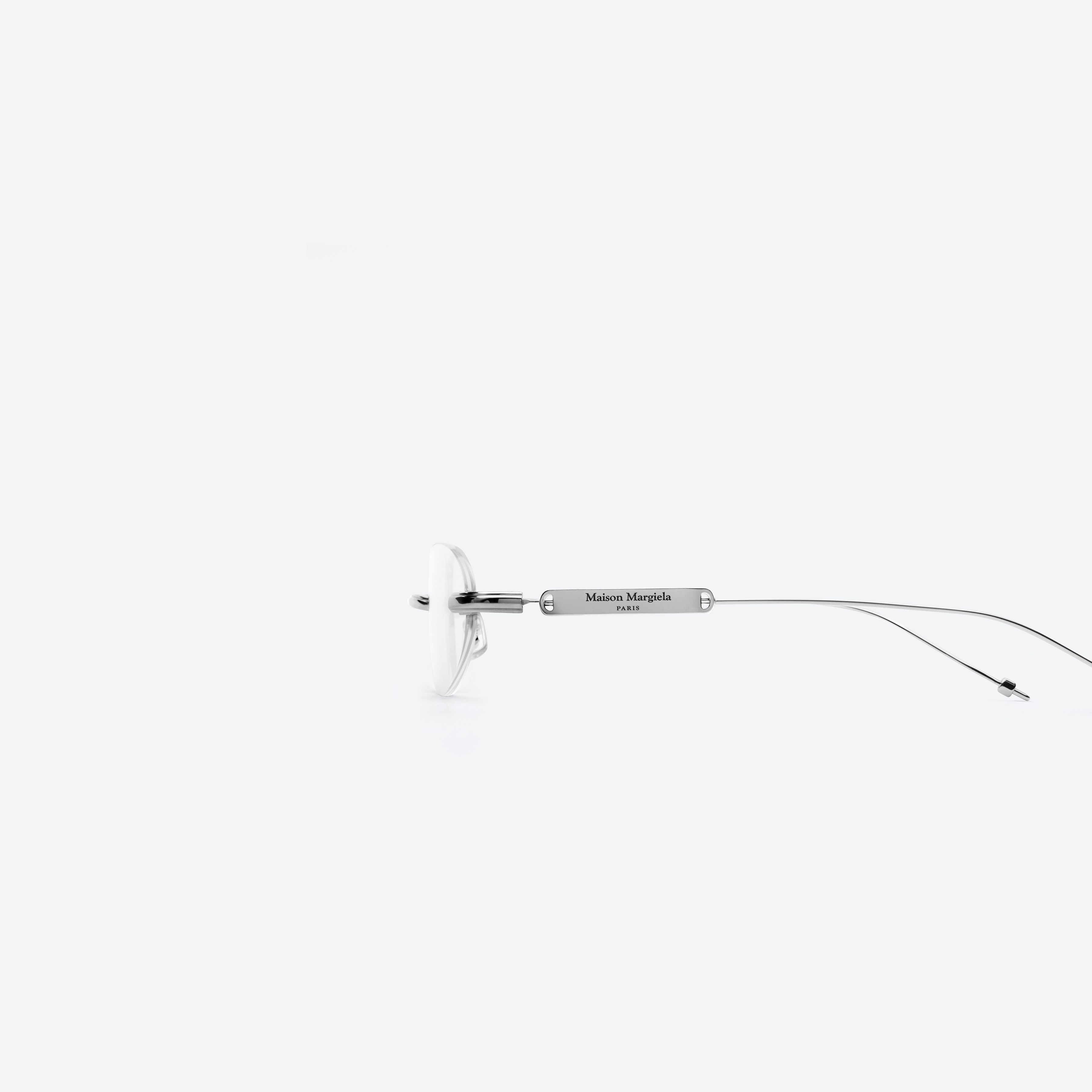 A detailed left view of Gentle Monster MM217 02 Silver Metal framed Oval glasses.