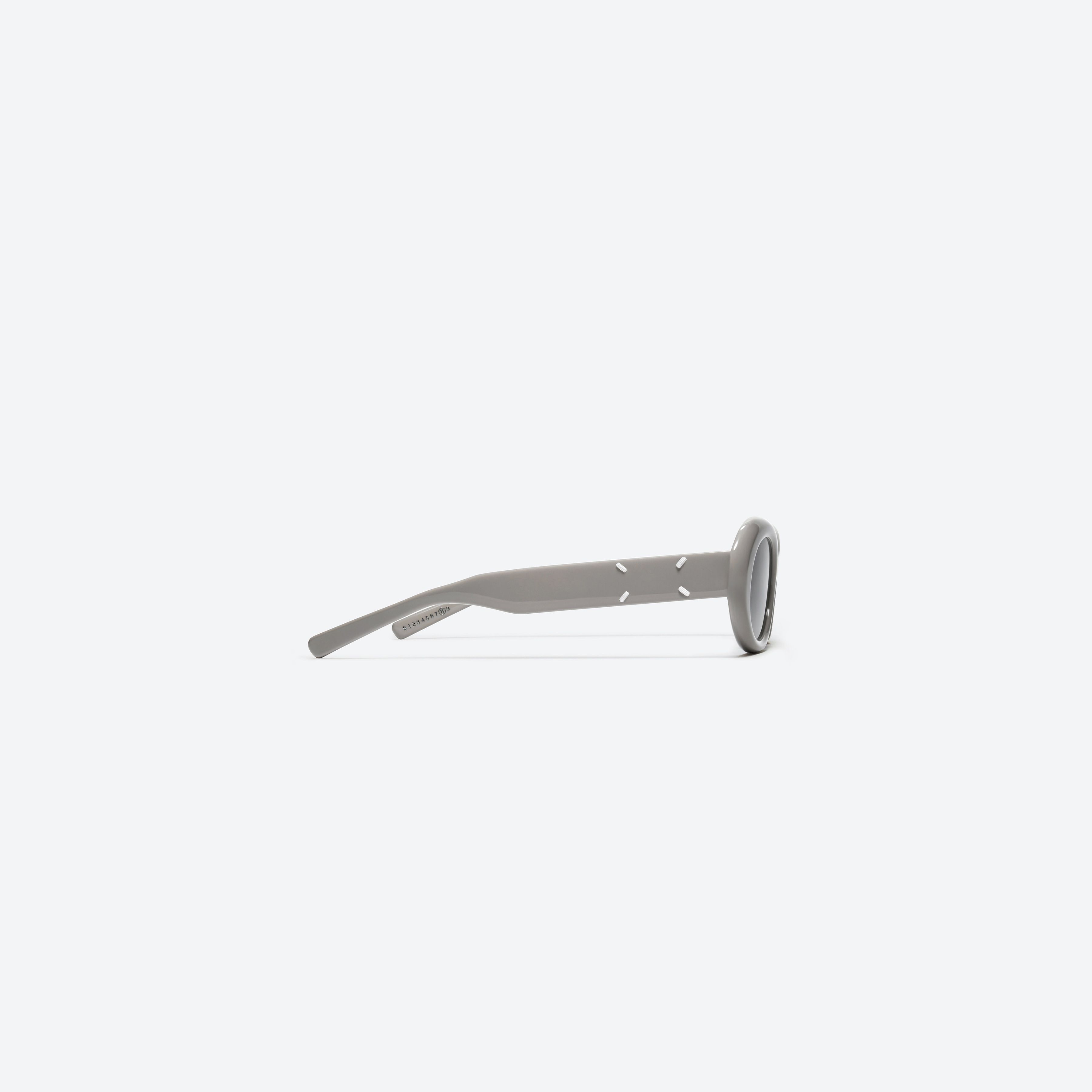 A detailed right view of Gentle Monster Maison Margiela - MM005 G10 Gray Acetate framed Oval sunglasses.