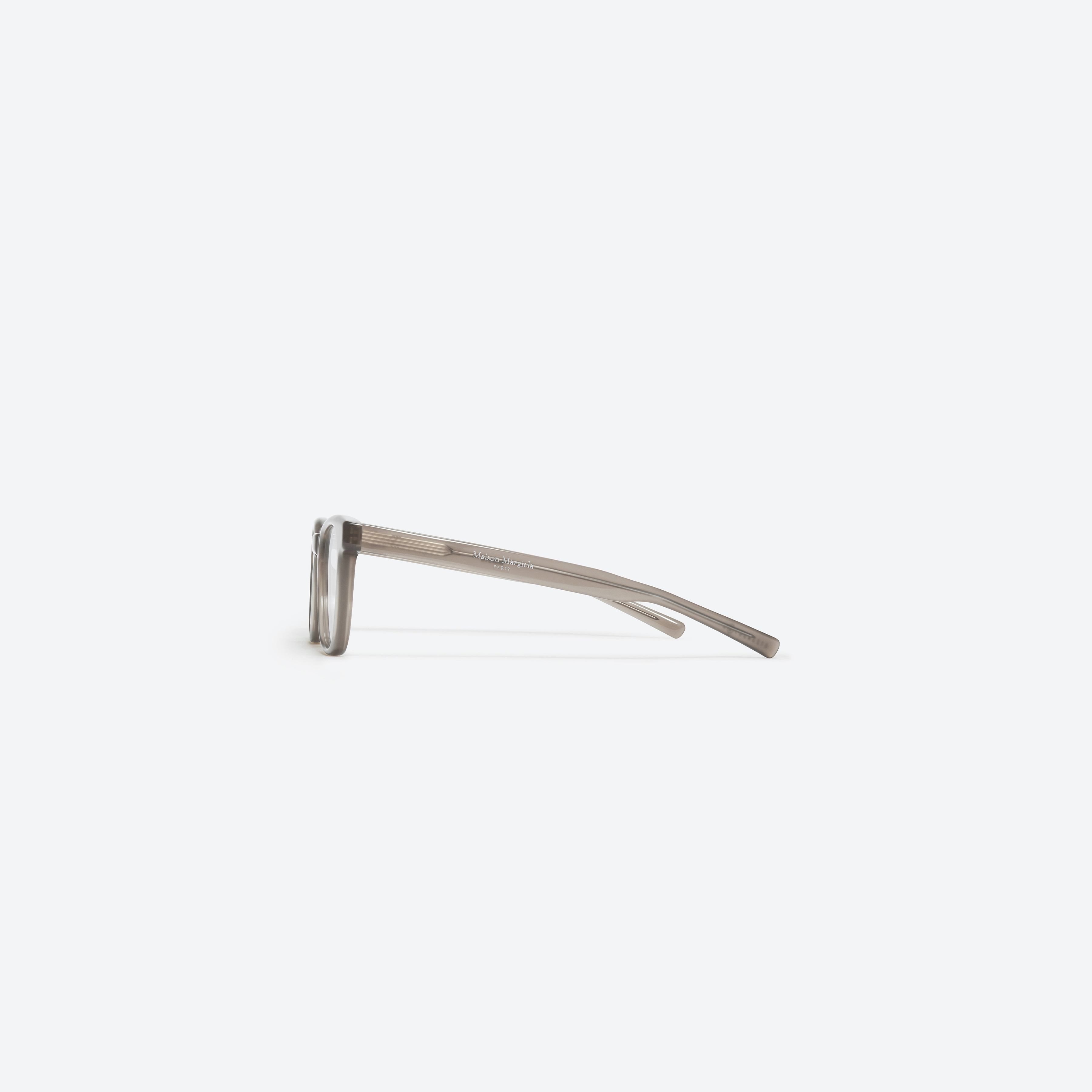 A detailed right view of Gentle Monster Maison Margiela - MM010 BRC9 Brown Acetate framed Square glasses.
