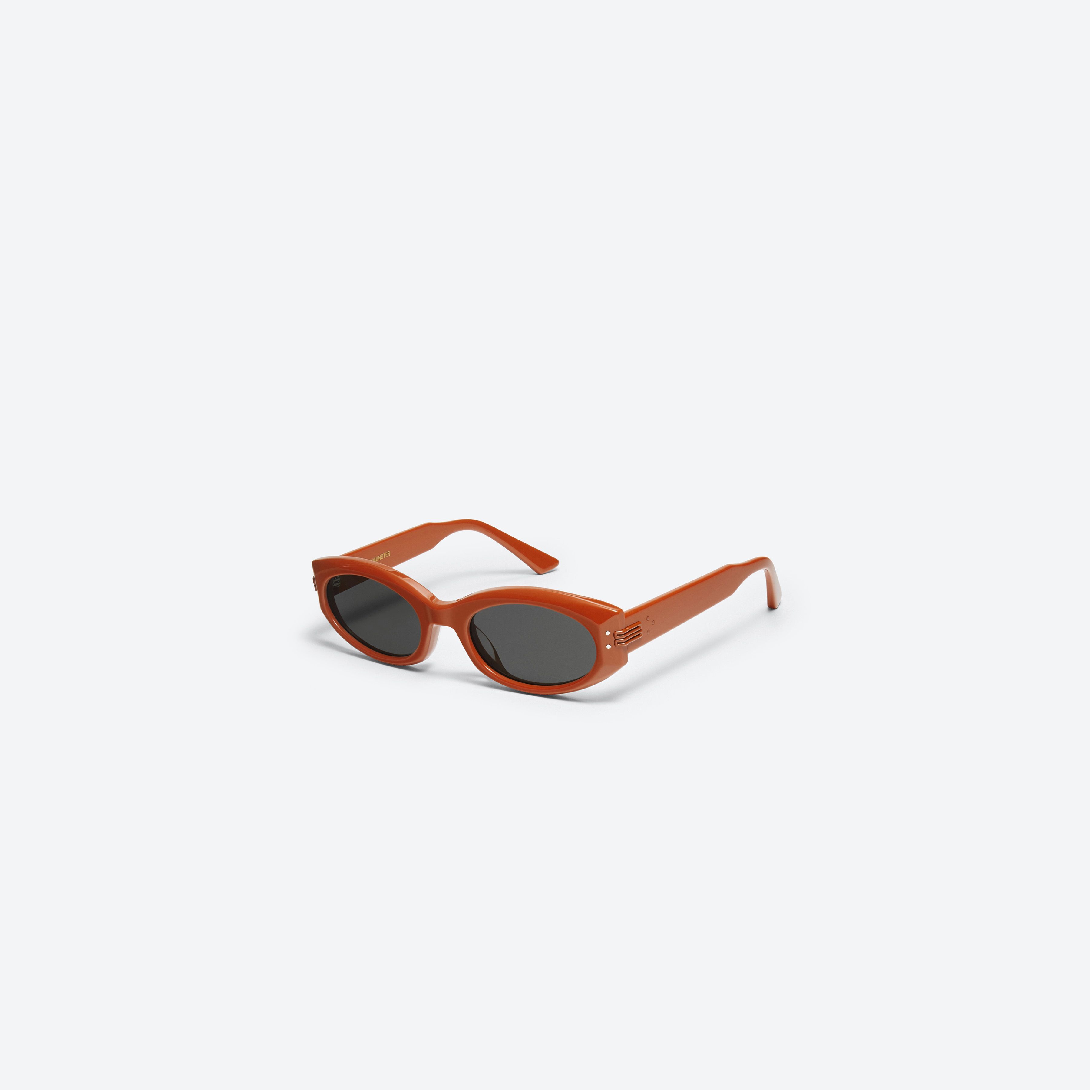 45-degree view of Gentle Monster Mass OR2 Orange Acetate framed Oval sunglasses.