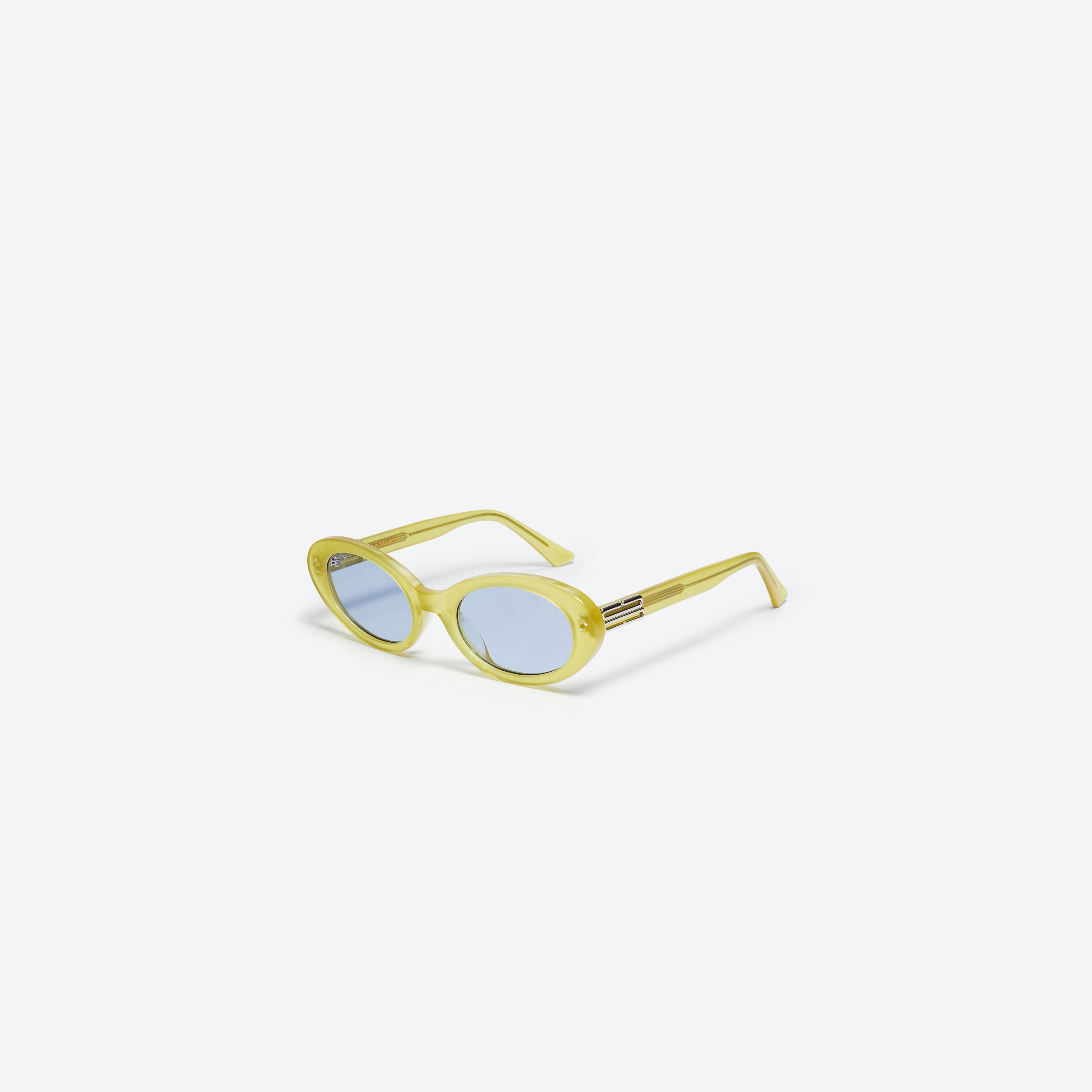 45-degree view of Gentle Monster Jeans OL3 Green Acetate framed Oval sunglasses.