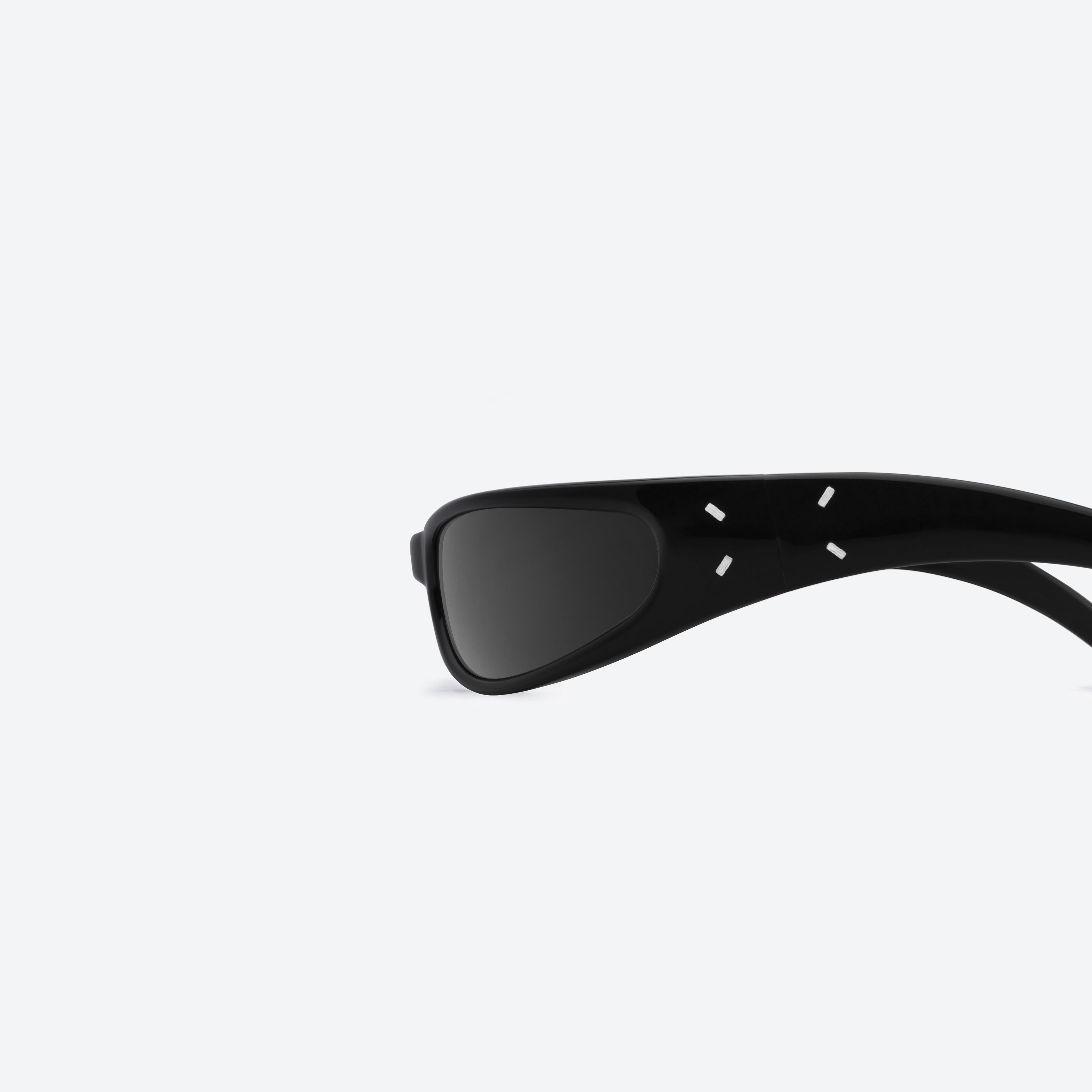 A detailed left view of Gentle Monster MM203 01 Black Acetate framed Wraparound sunglasses.