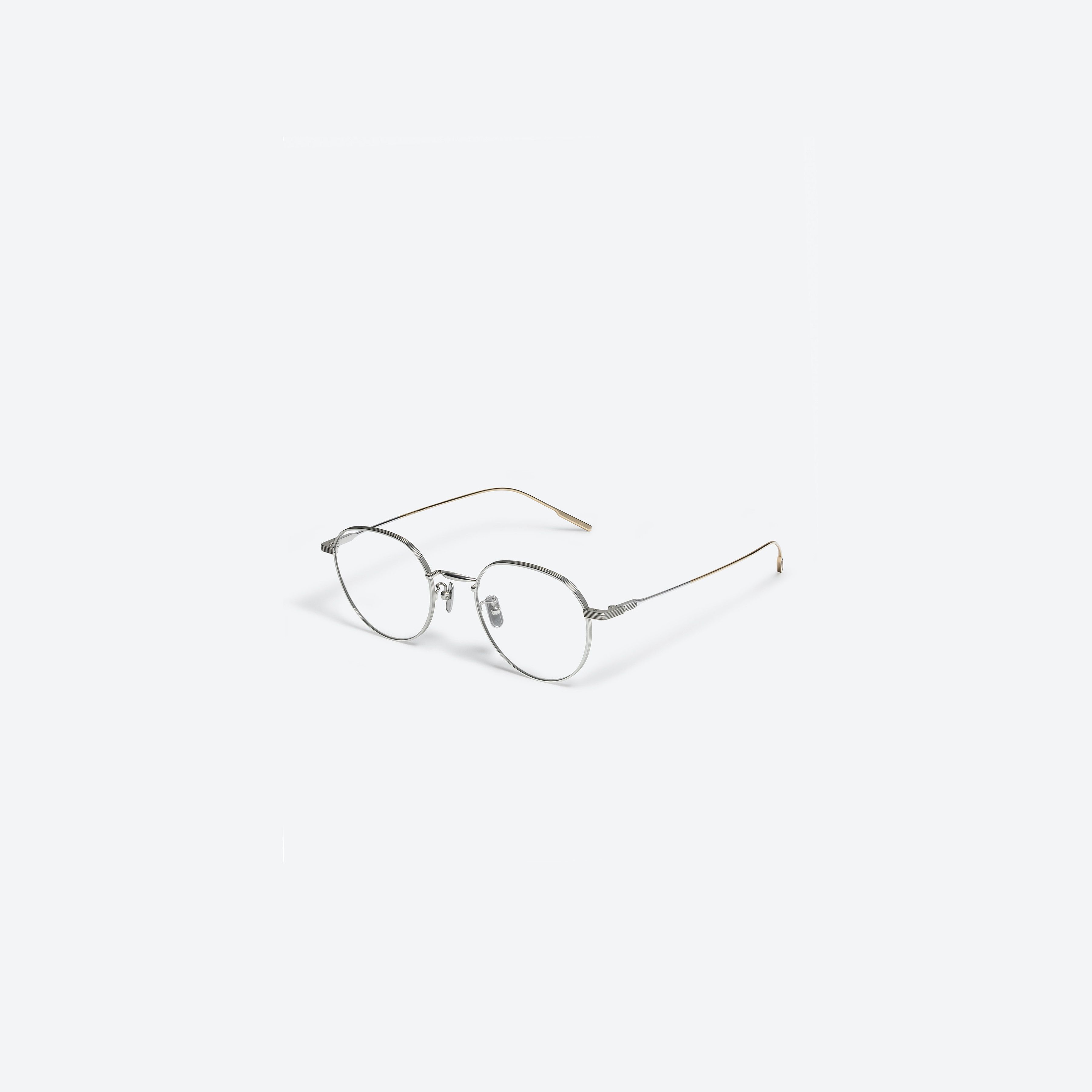 45-degree view of Gentle Monster Yona 02 Silver Metal framed Round glasses.