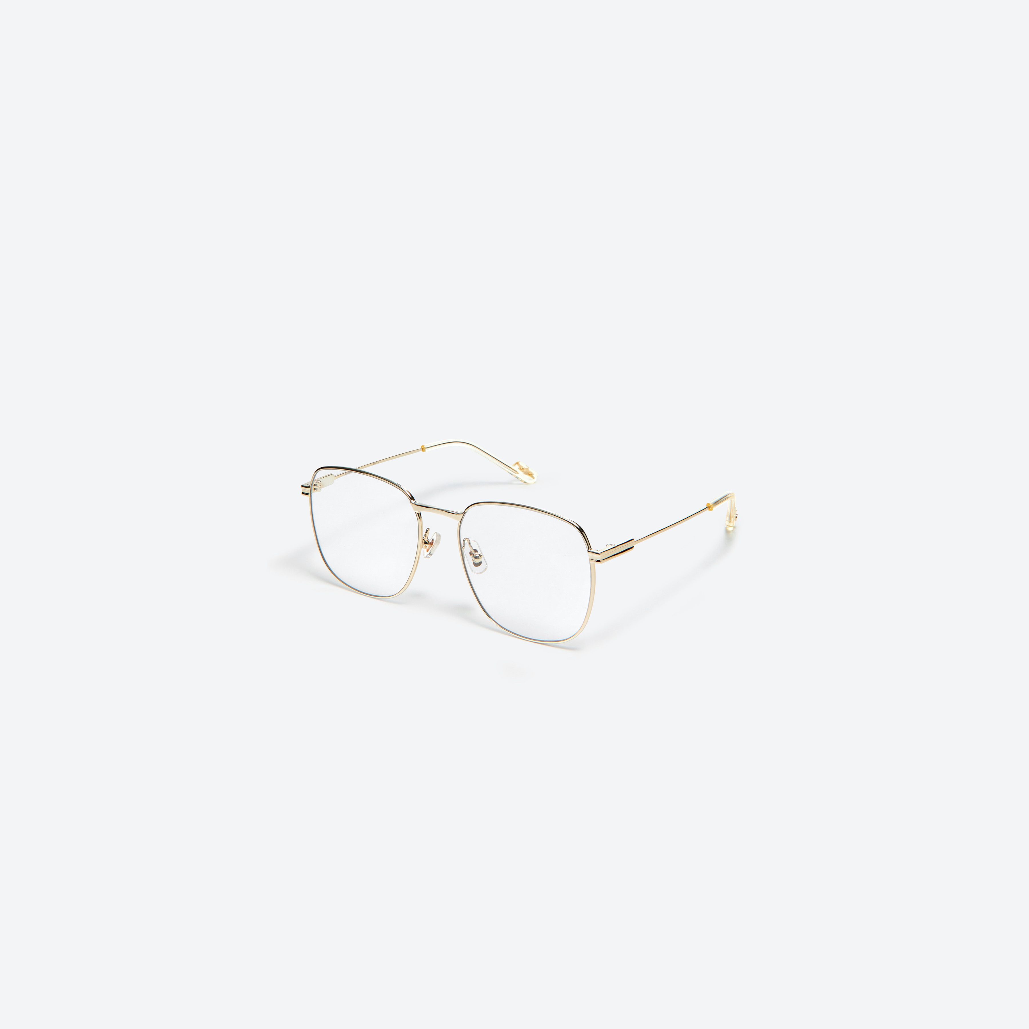 45-degree view of Gentle Monster Onil 031 Gold Metal framed Square glasses.