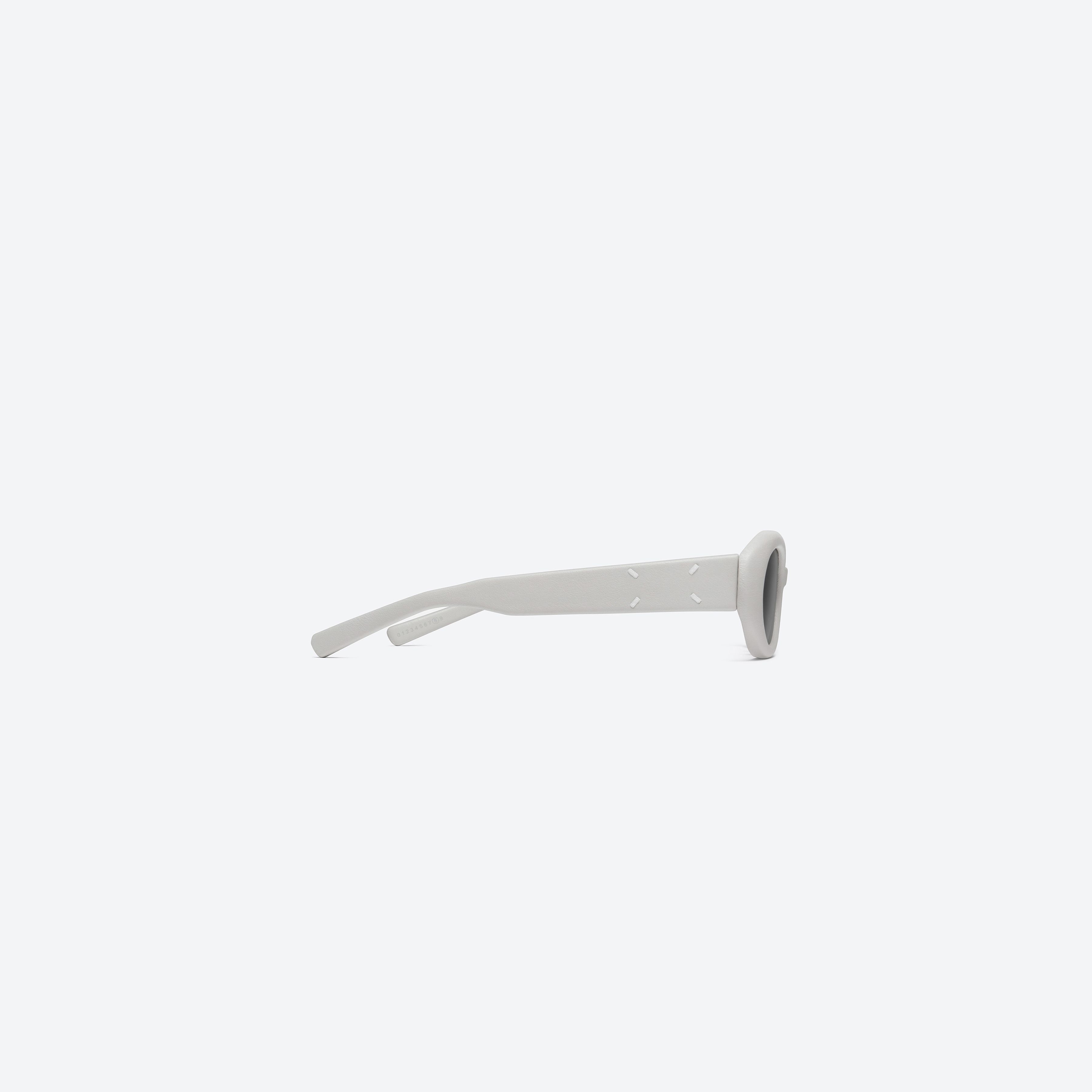 A detailed right view of Gentle Monster Maison Margiela - MM107 Leather LIV1 Ivory Acetate framed Oval sunglasses.