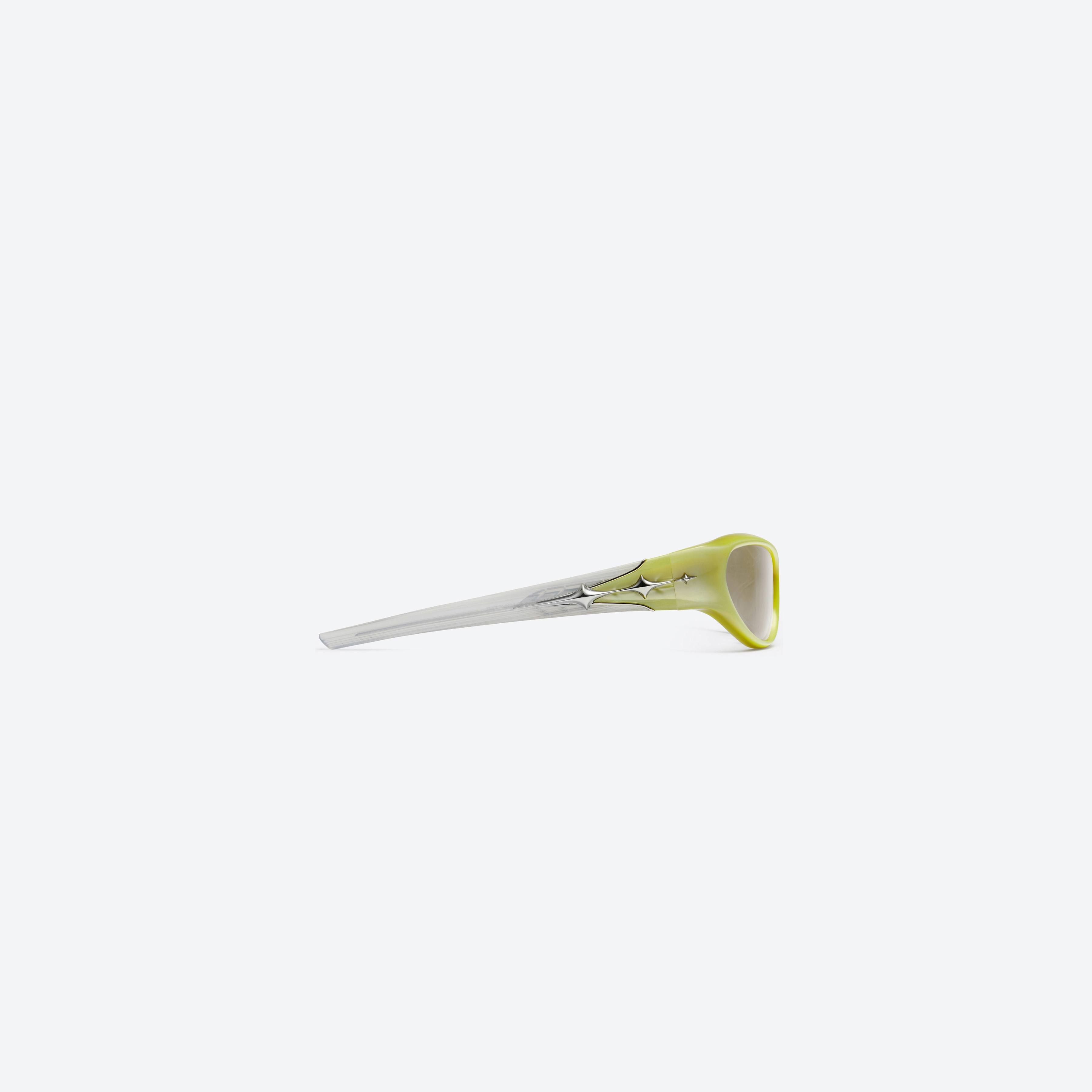 A detailed right view of Gentle Monster Limitless SY9 Yellow Acetate framed Wraparound sunglasses.