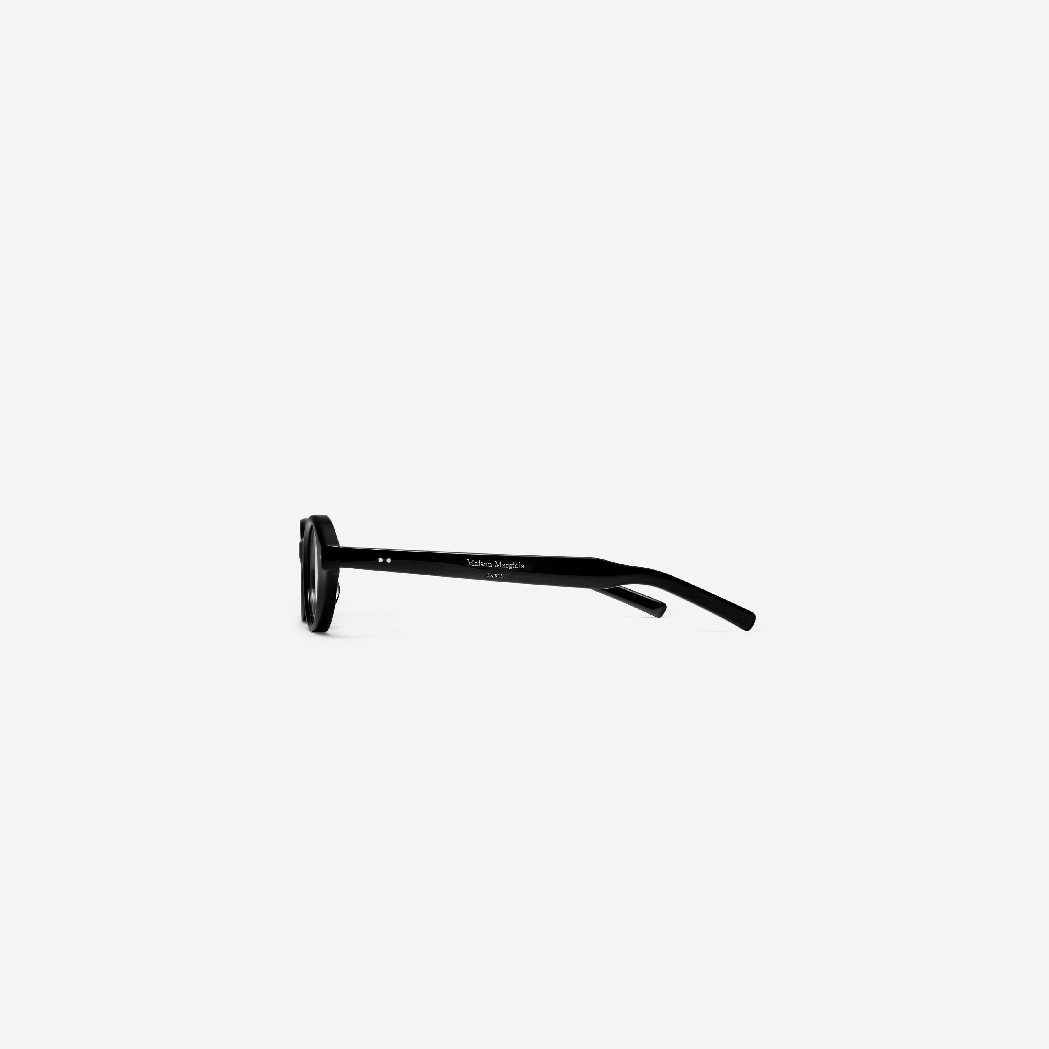 A detailed right view of Gentle Monster Maison Margiela - MM111 01 Black Acetate framed Oval glasses.