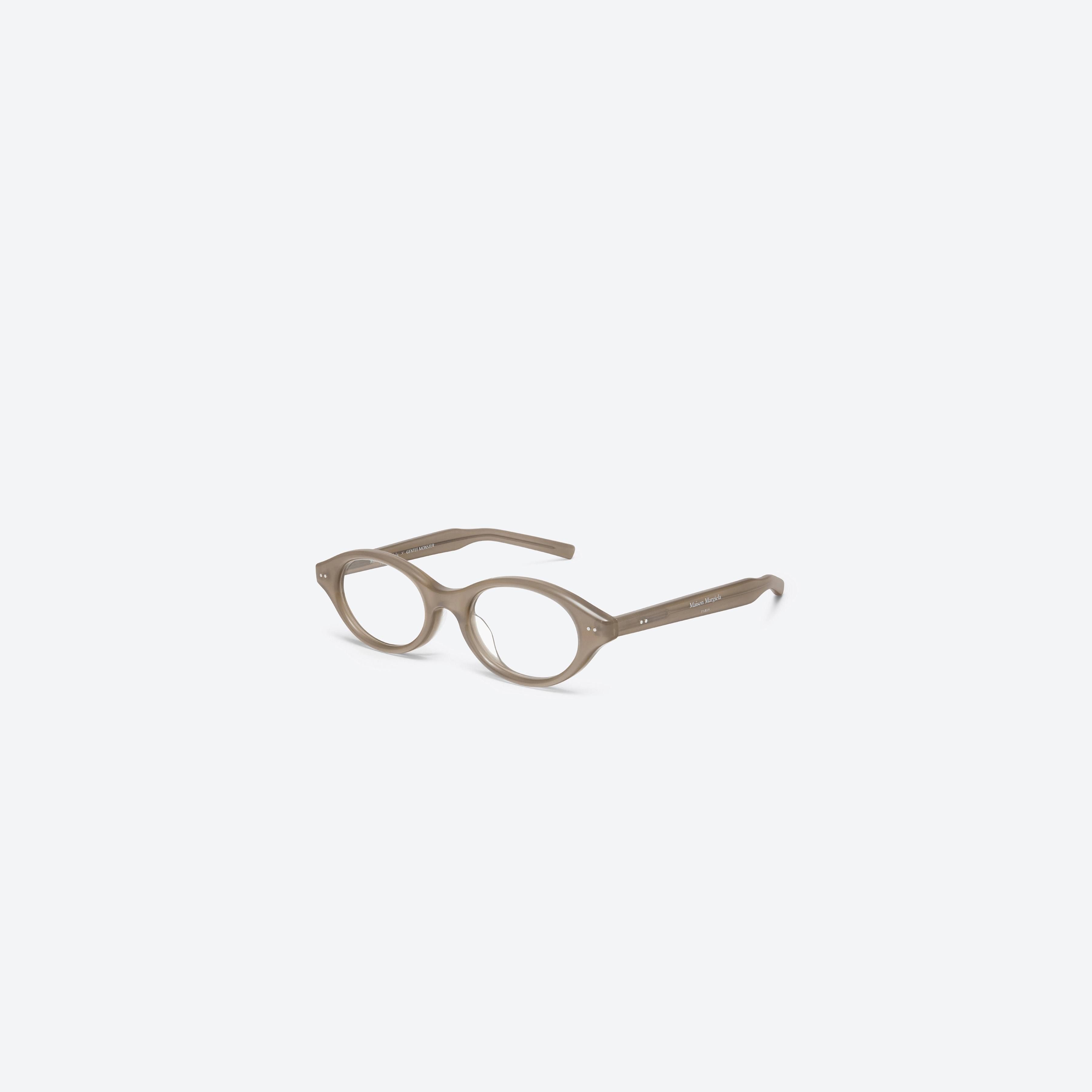 45-degree view of Gentle Monster Maison Margiela - MM111 BRC9 Brown Acetate framed Oval glasses.