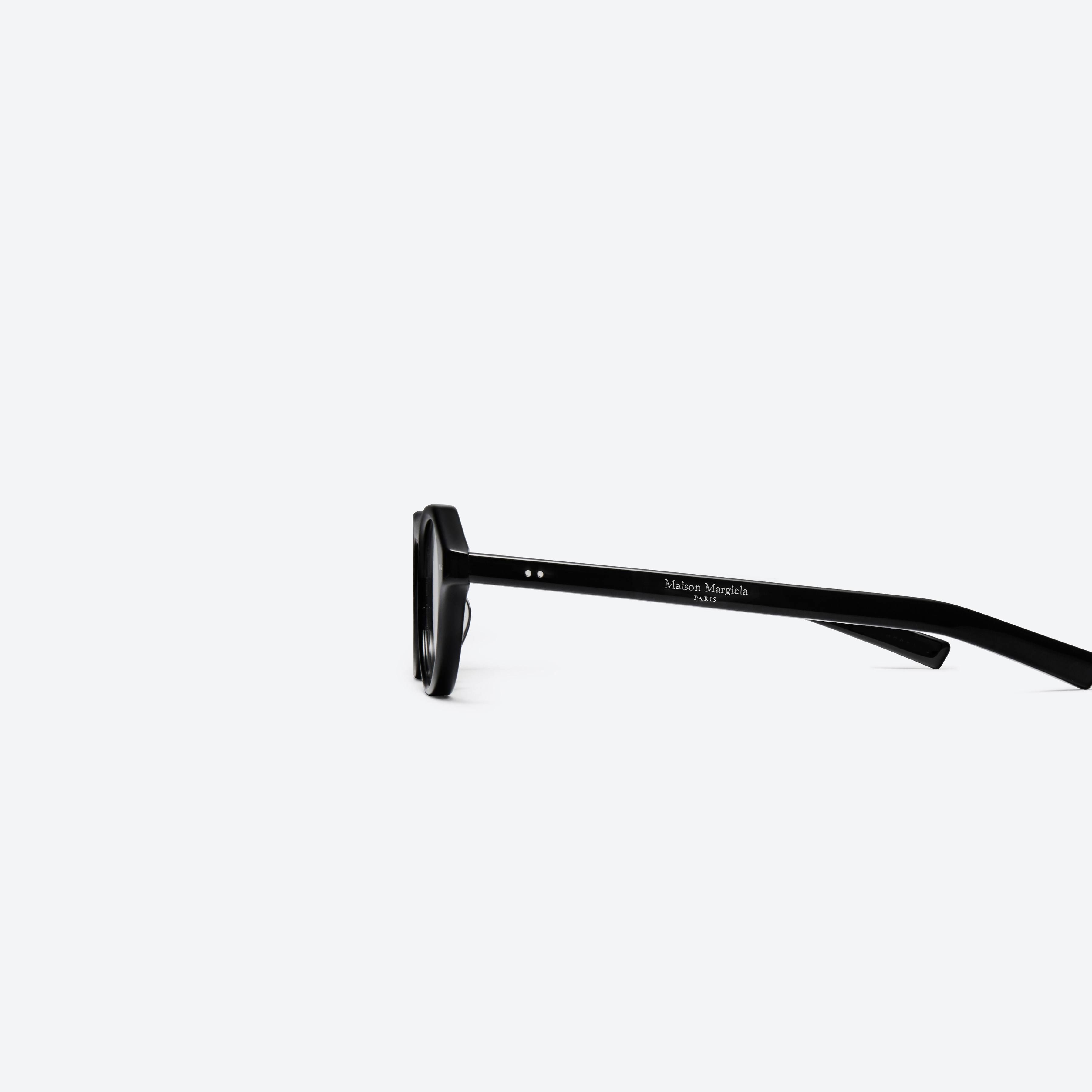 A detailed left view of Gentle Monster Maison Margiela - MM112 01 Black Acetate framed Aviator glasses.