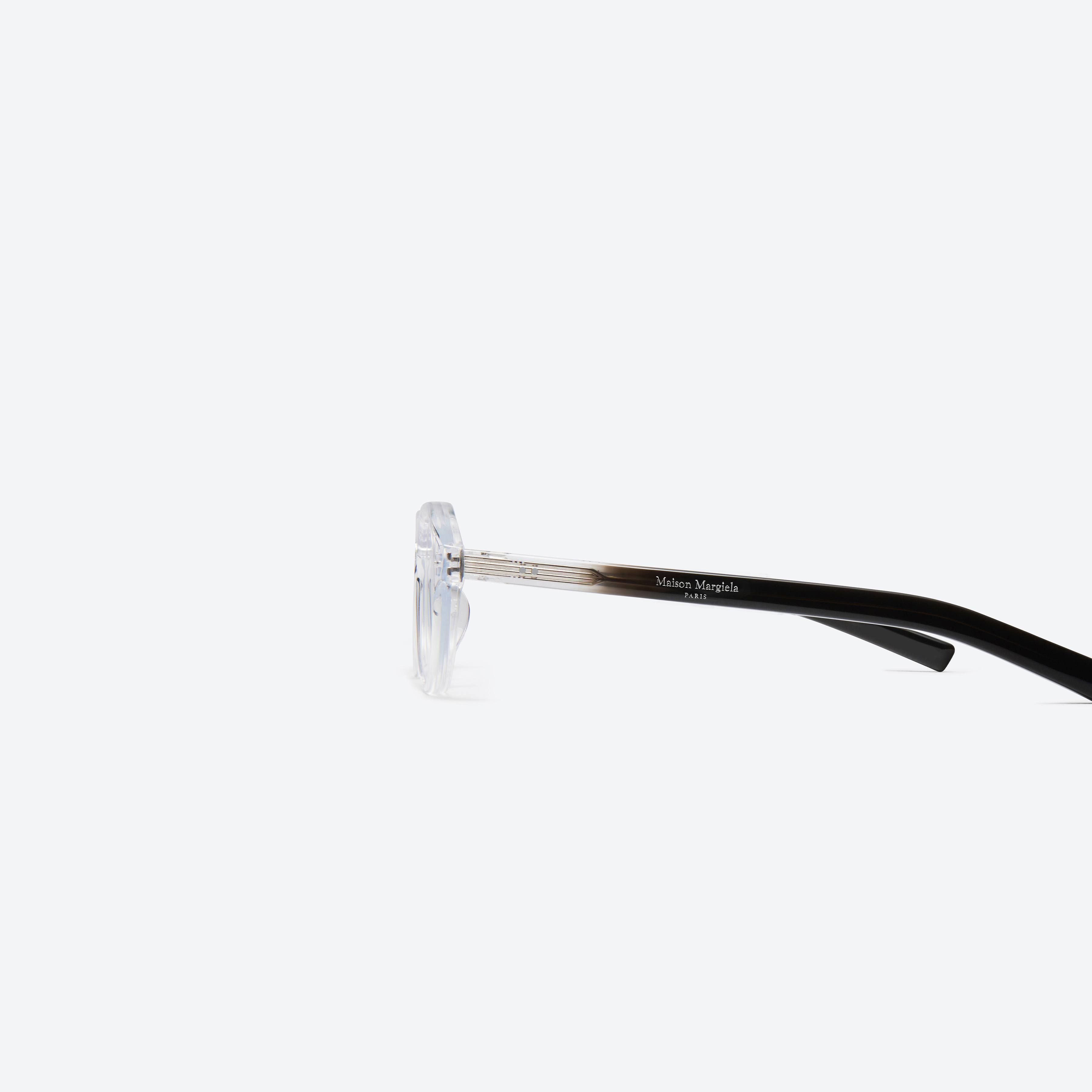 A detailed left view of Gentle Monster Maison Margiela - MM112 C1 Clear Acetate framed Aviator glasses.