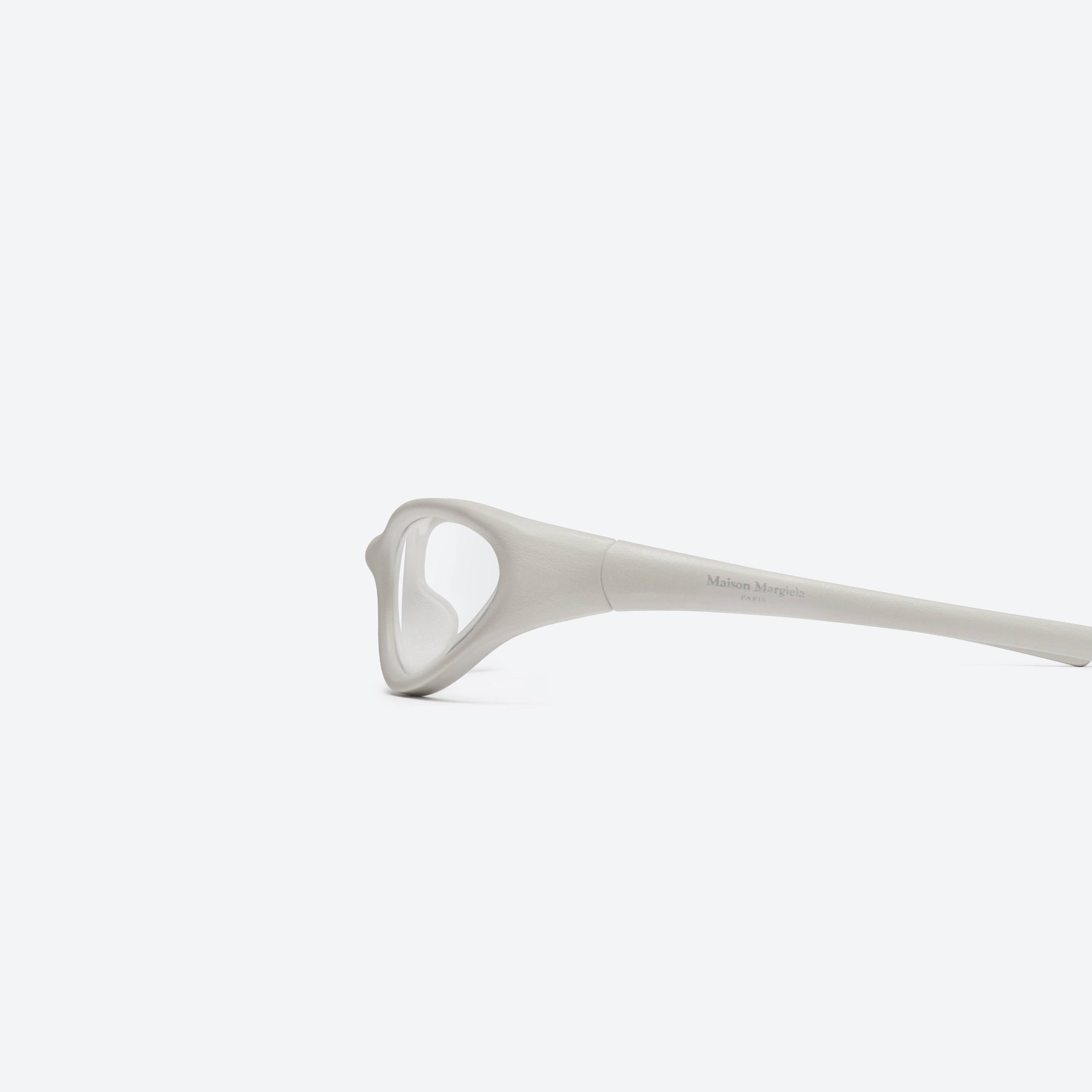 A detailed left view of Gentle Monster Maison Margiela - MM115 Leather LIV1 Ivory Acetate framed Wraparound glasses.