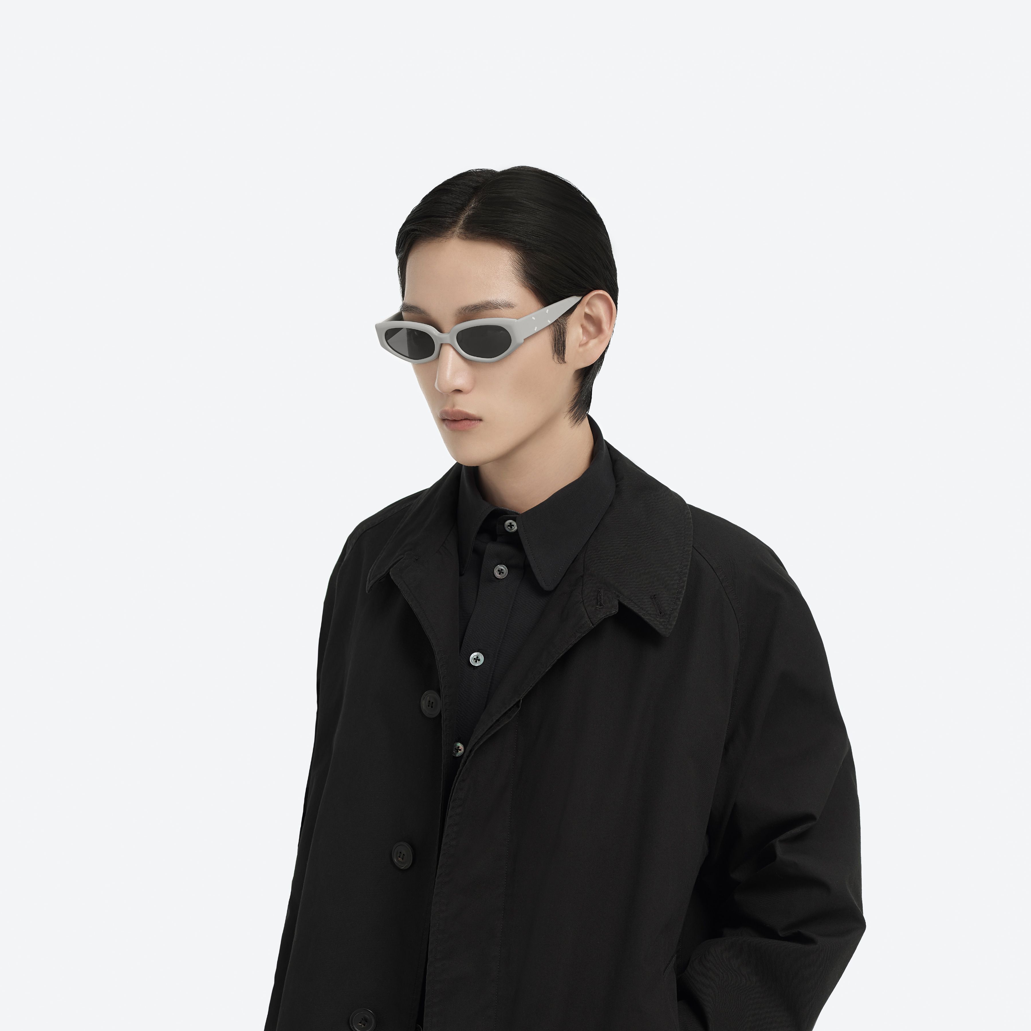 Model wearing the Maison Margiela - MM205 G12 Gray Acetate framed Cat-eye sunglasses.