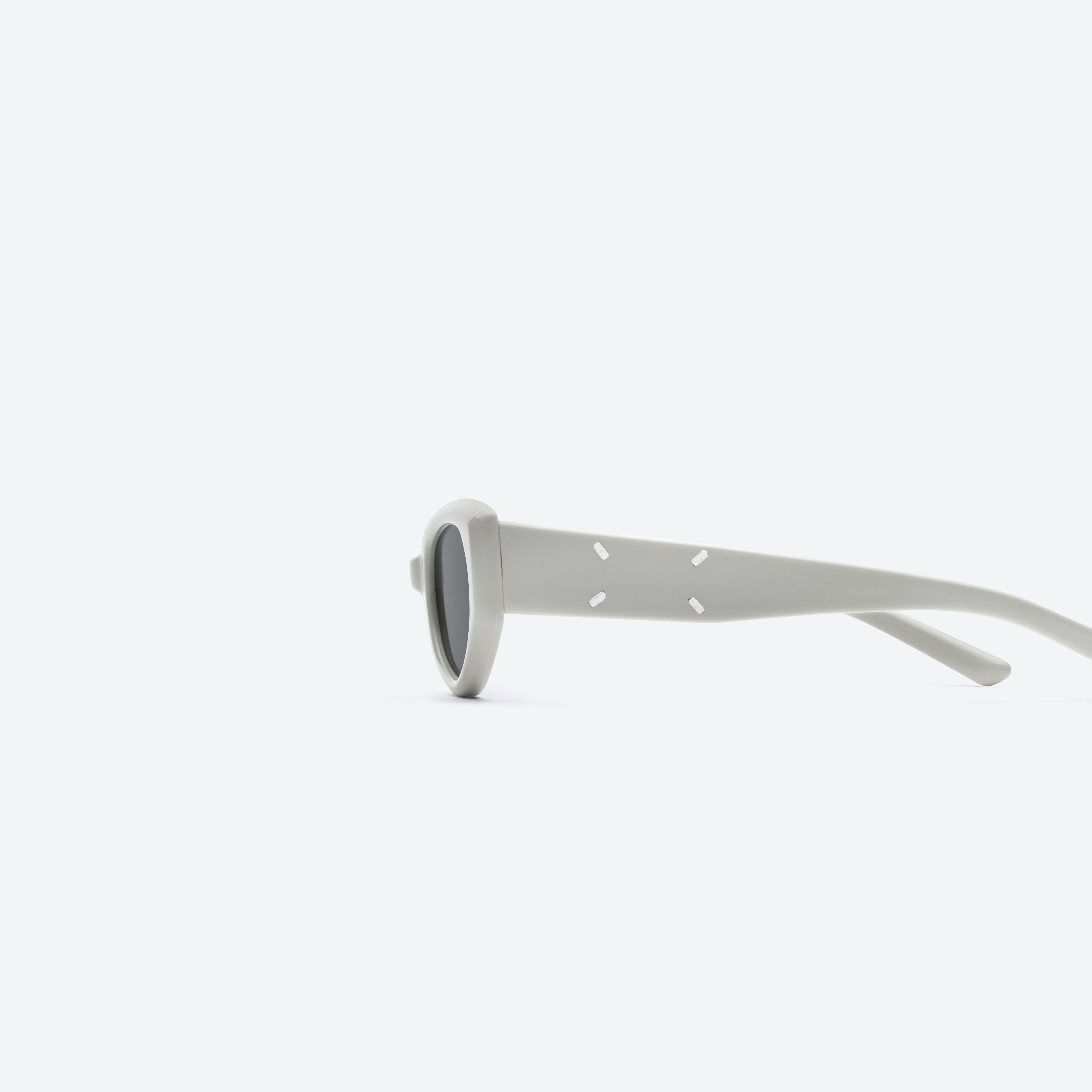 A detailed left view of Gentle Monster Maison Margiela - MM205 G12 Gray Acetate framed Cat-eye sunglasses.