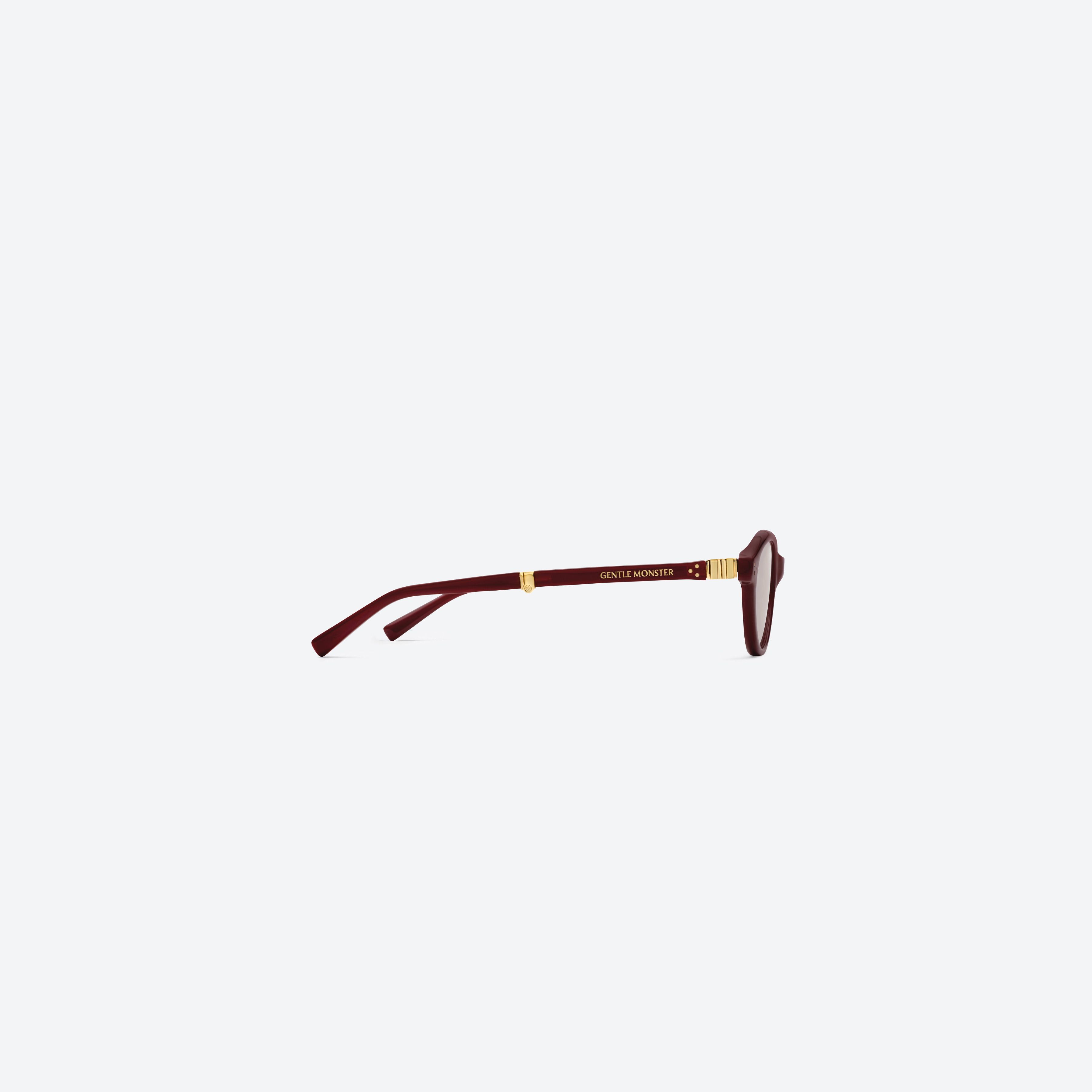 A detailed right view of Gentle Monster Takion R8 Red Acetate framed Round glasses.