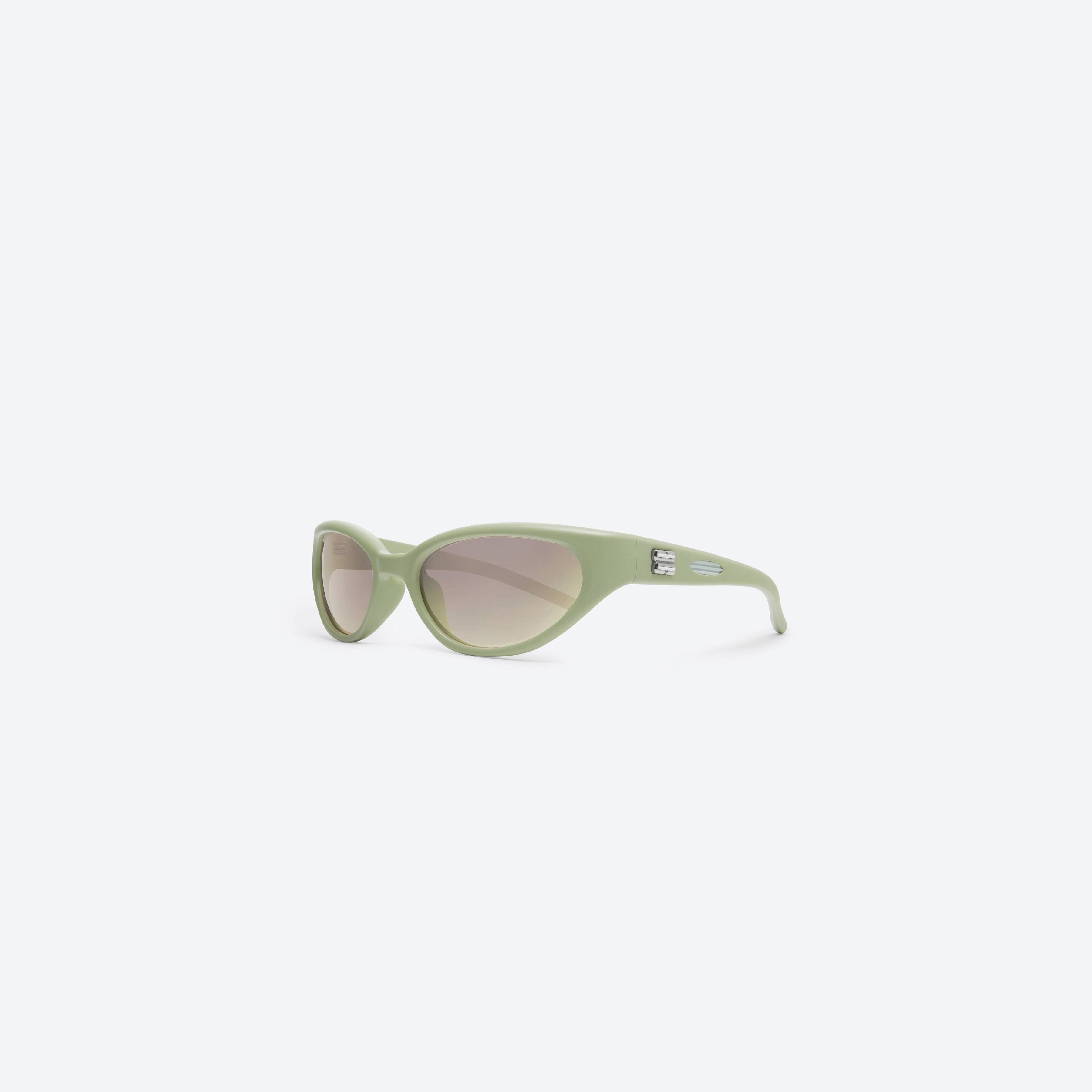 45-degree view of Gentle Monster Juicy GR7 Green Nylon framed Wraparound sunglasses.