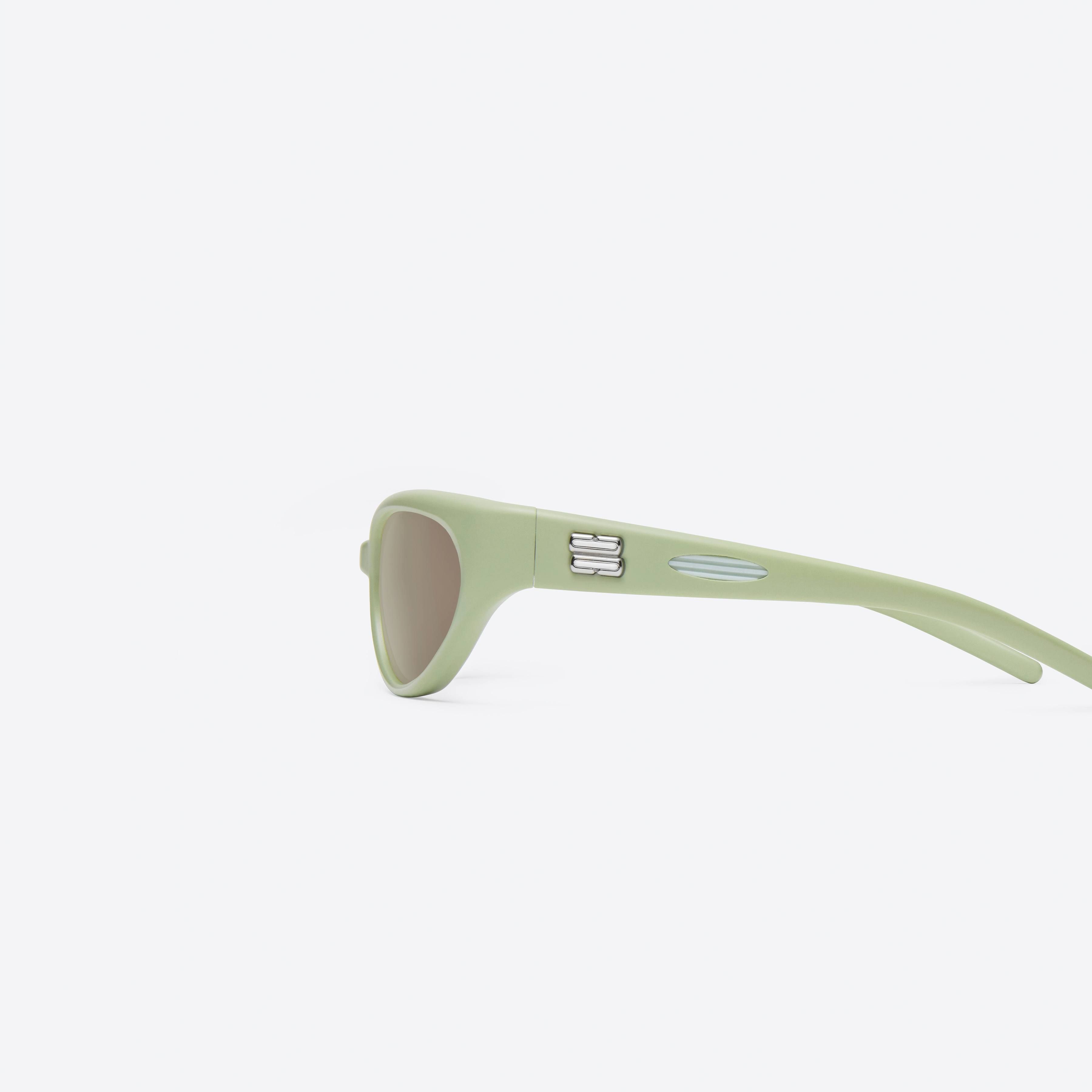 A detailed left view of Gentle Monster Juicy GR7 Green Nylon framed Wraparound sunglasses.