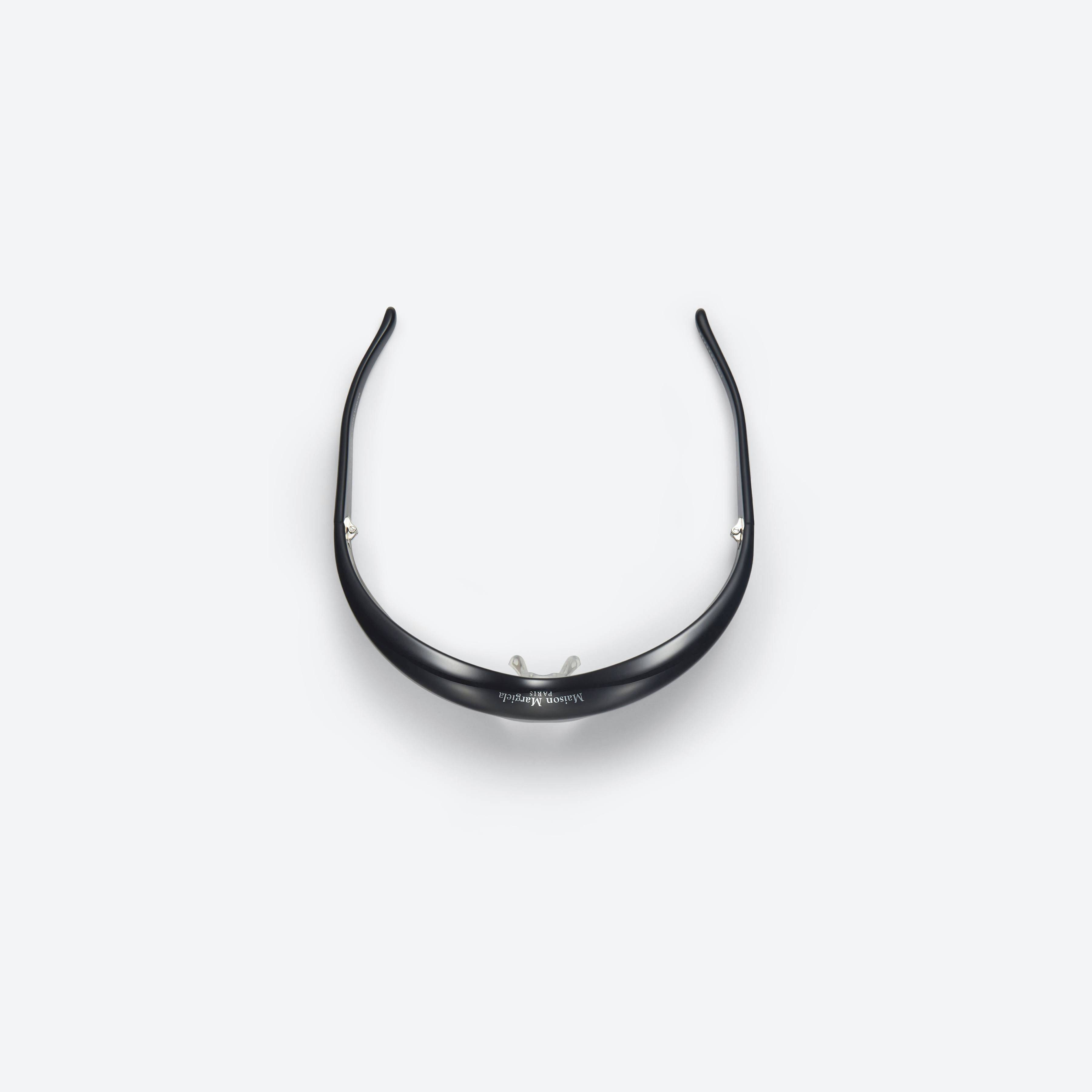 A detailed left view of Gentle Monster Maison Margiela - MM002 01 Black Acetate framed Wraparound sunglasses.