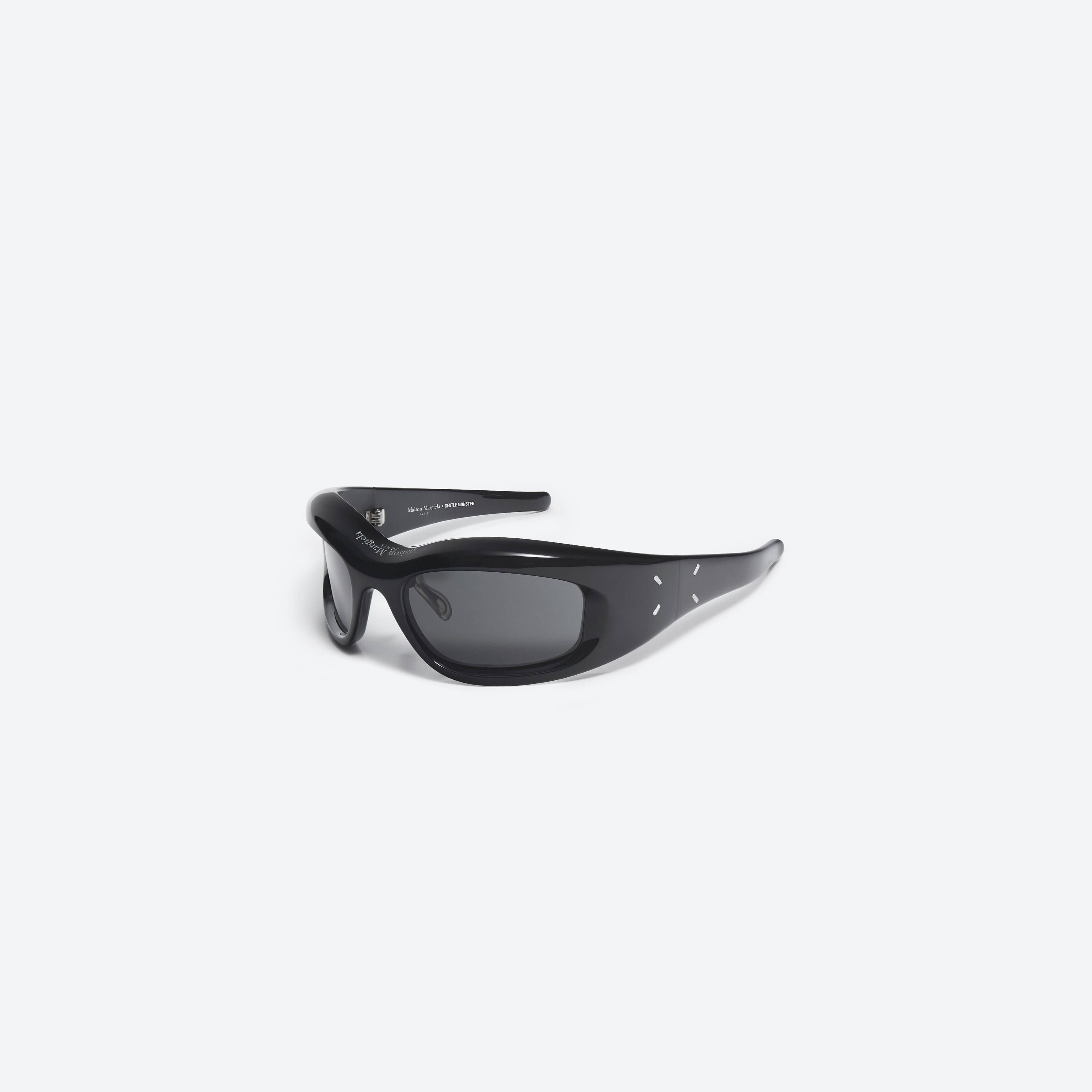 45-degree view of Gentle Monster Maison Margiela - MM002 01 Black Acetate framed Wraparound sunglasses.