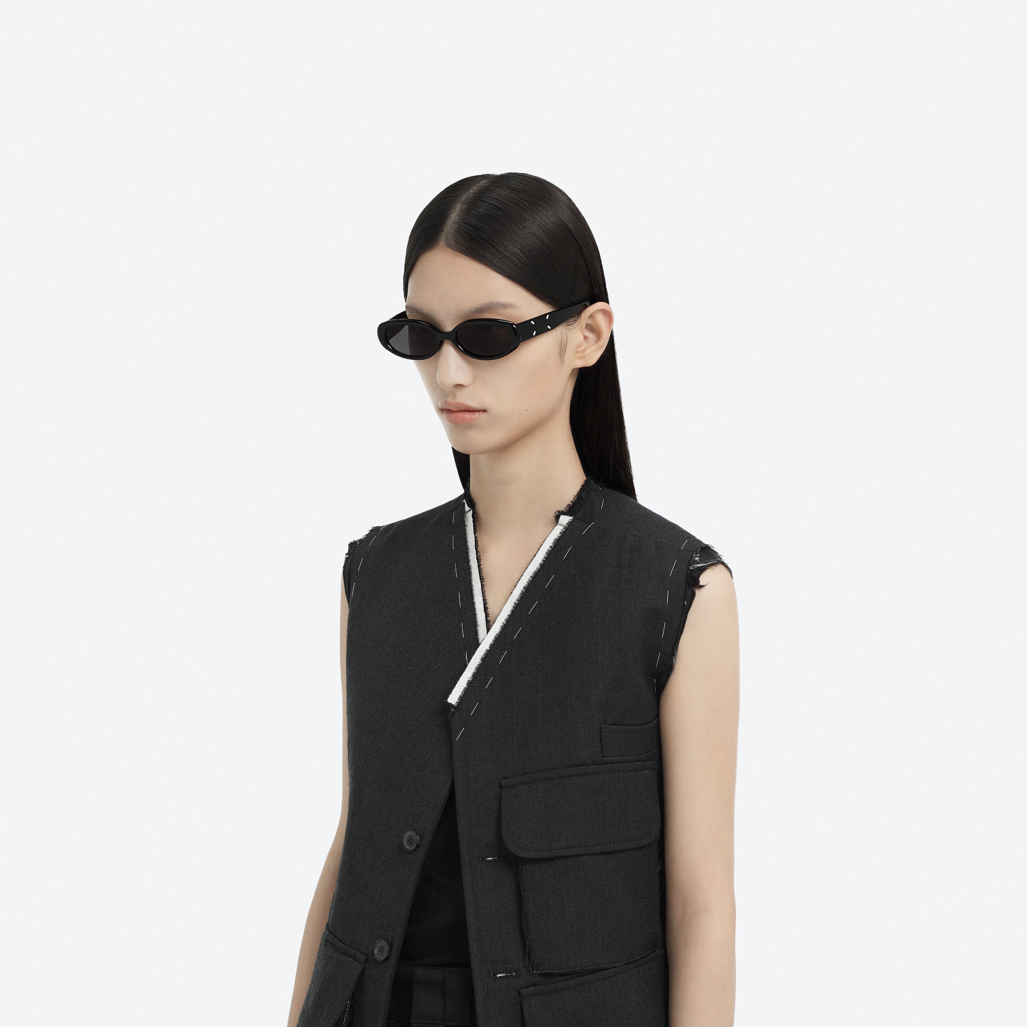Model wearing the MM206 01 Black Acetate framed Oval sunglasses.