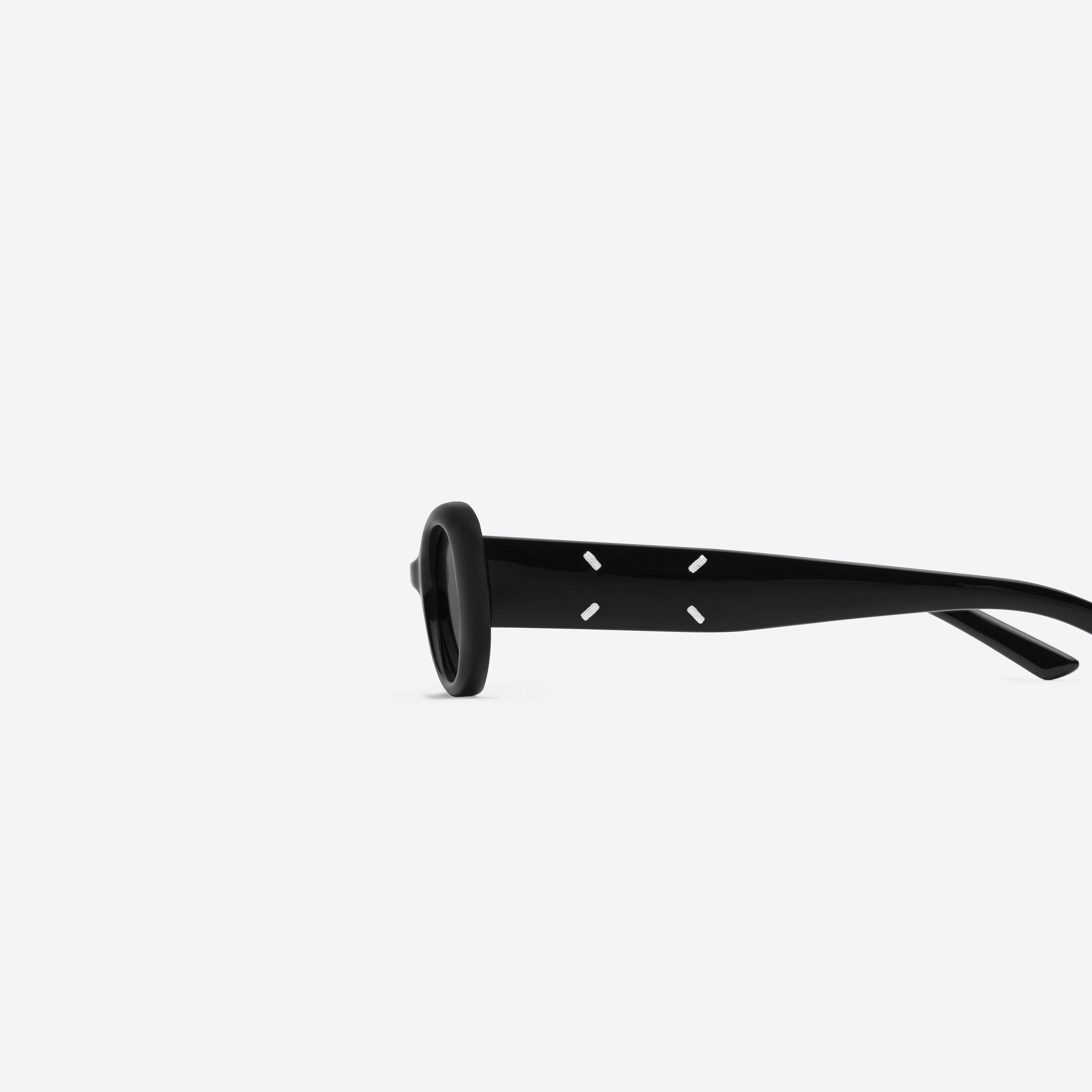 A detailed left view of Gentle Monster MM206 01 Black Acetate framed Oval sunglasses.
