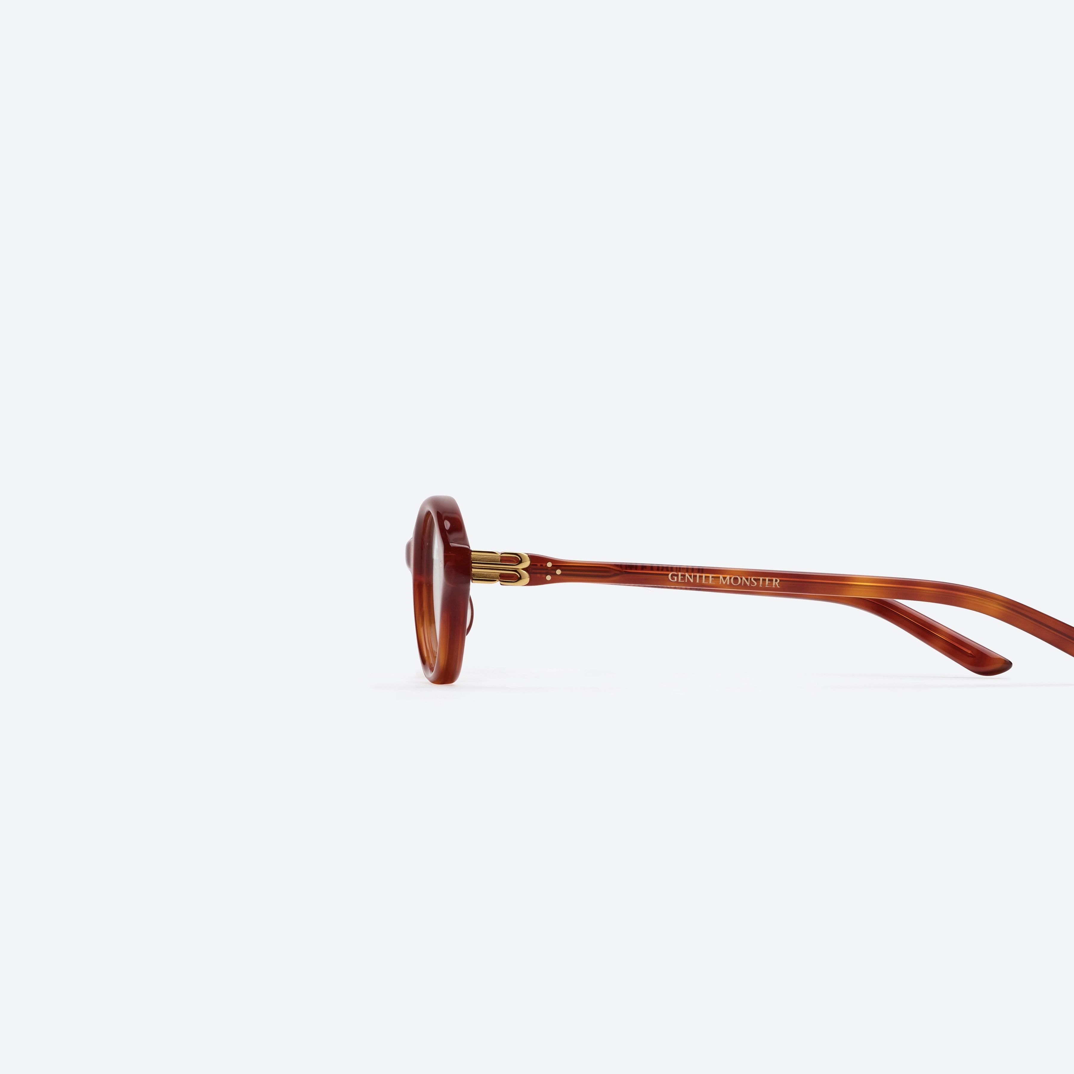 A detailed left view of Gentle Monster Corori T4 Tortoise Acetate framed Oval glasses.