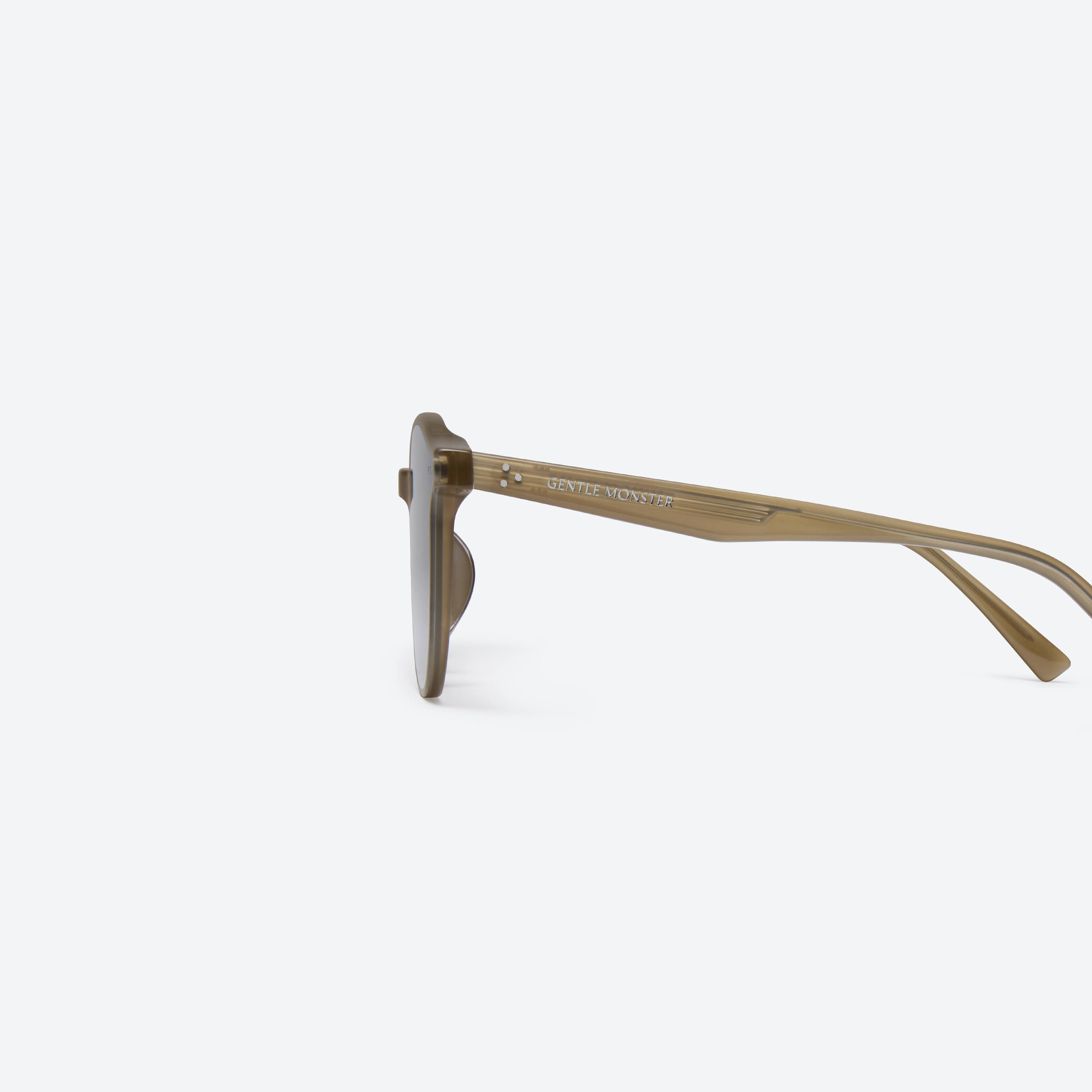 A detailed left view of Gentle Monster New Born BRC9 Brown Acetate framed Round sunglasses.