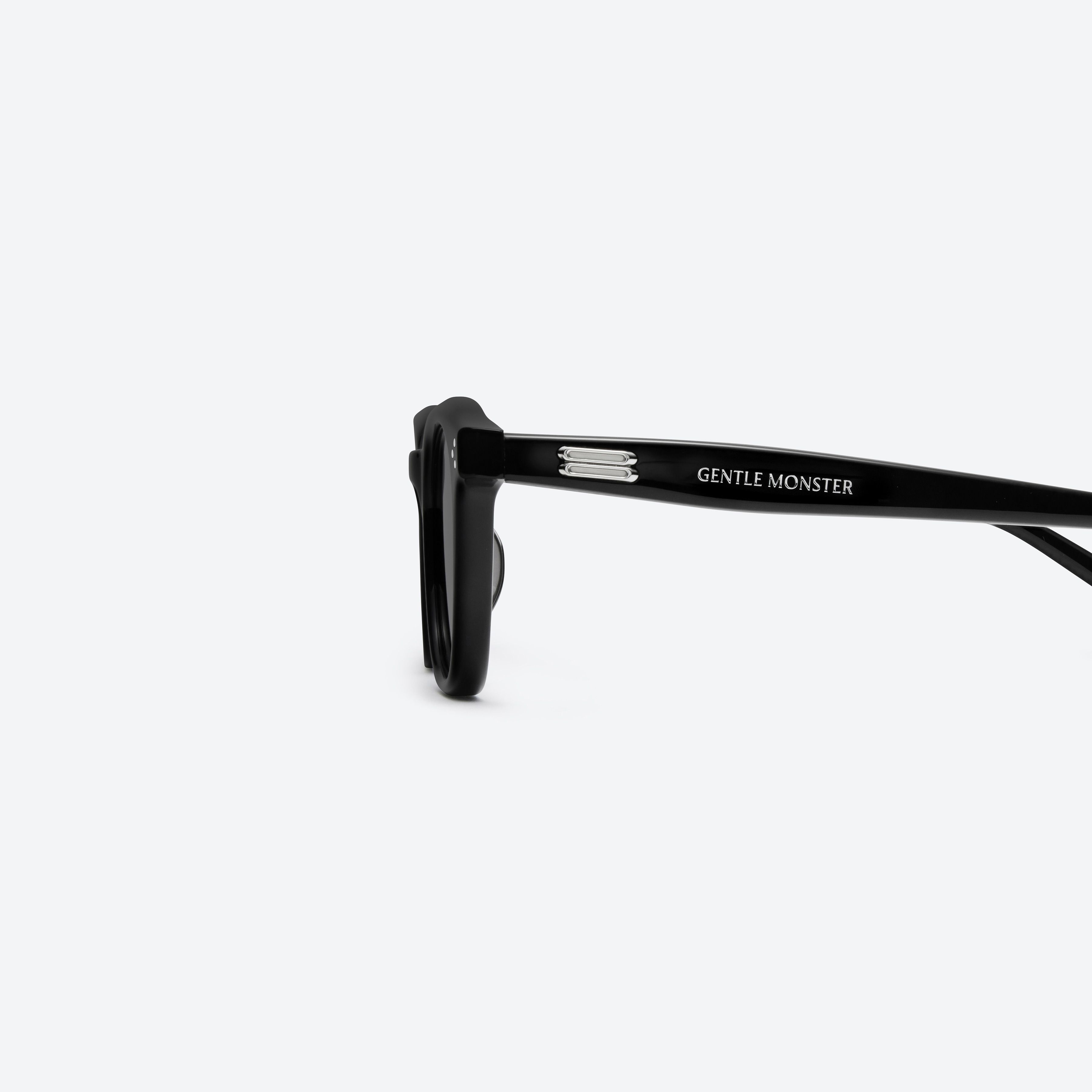 A detailed left view of Gentle Monster Noho.s 01 Black Acetate framed Round sunglasses.